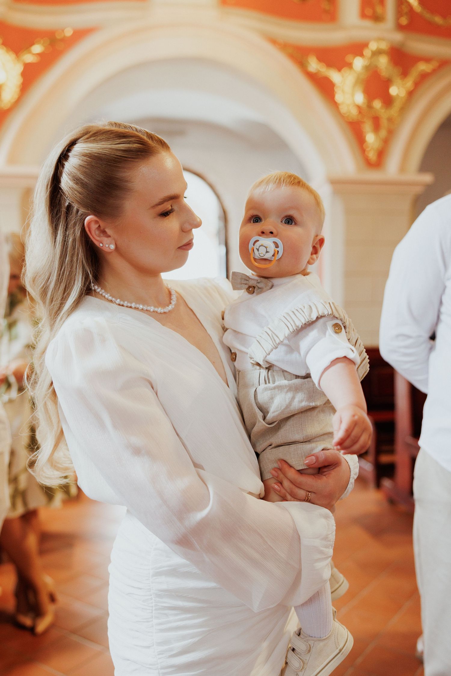 A tender dance moment captured at an elegant venue with warm lighting and ornate decor.