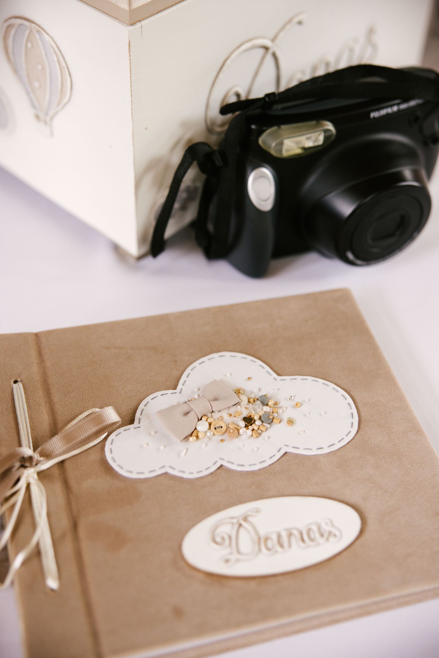 Vintage-style photo album or guestbook with cloud designs on kraft paper cover.