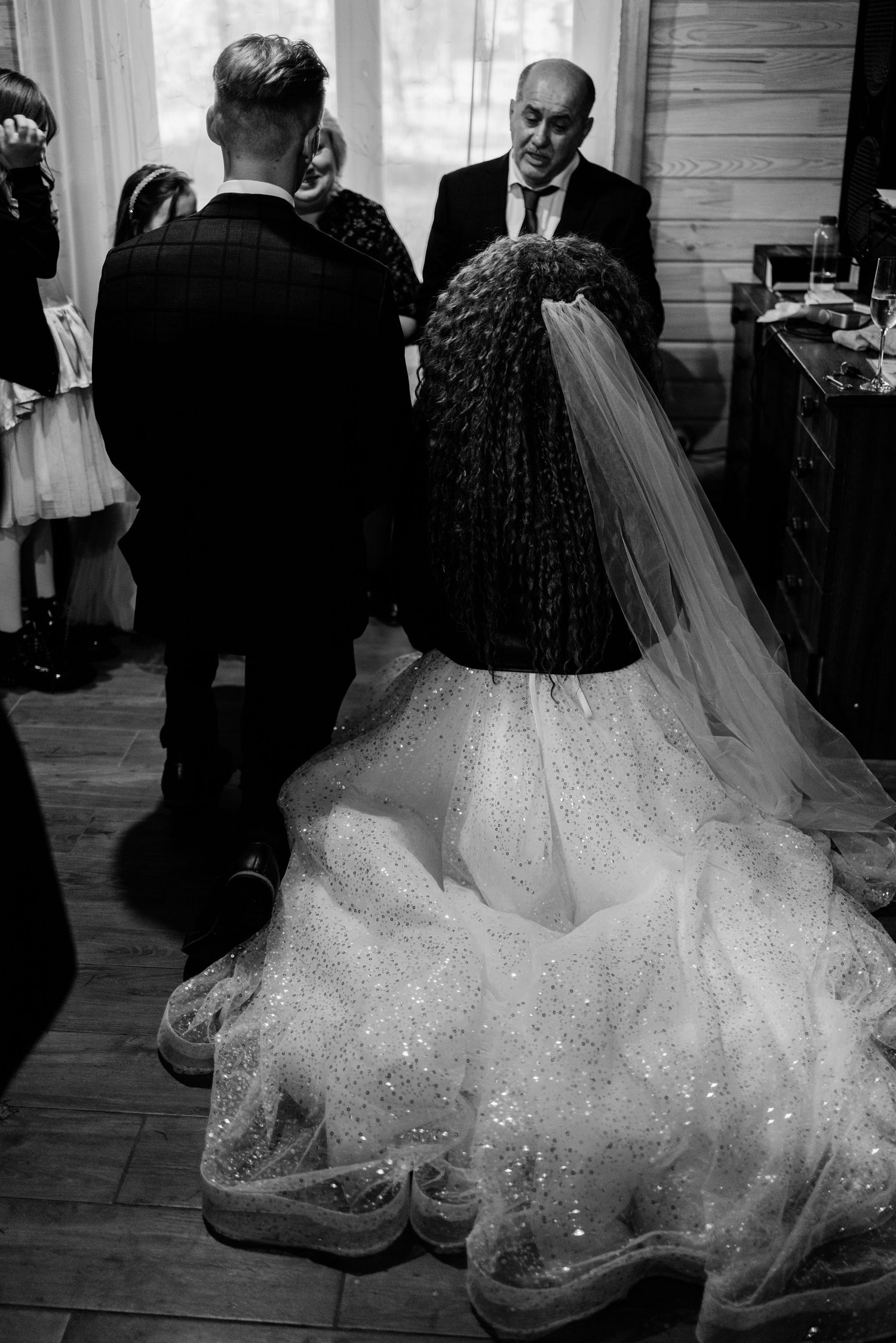 A sequence of black and white wedding photos showing the flowing movement of a sparkly ballgown wedding dress.