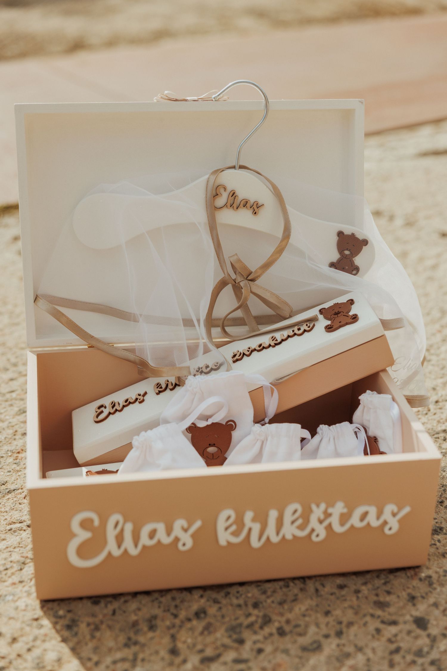 White acrylic name plates with elegant cursive text arranged in box with tissue paper.