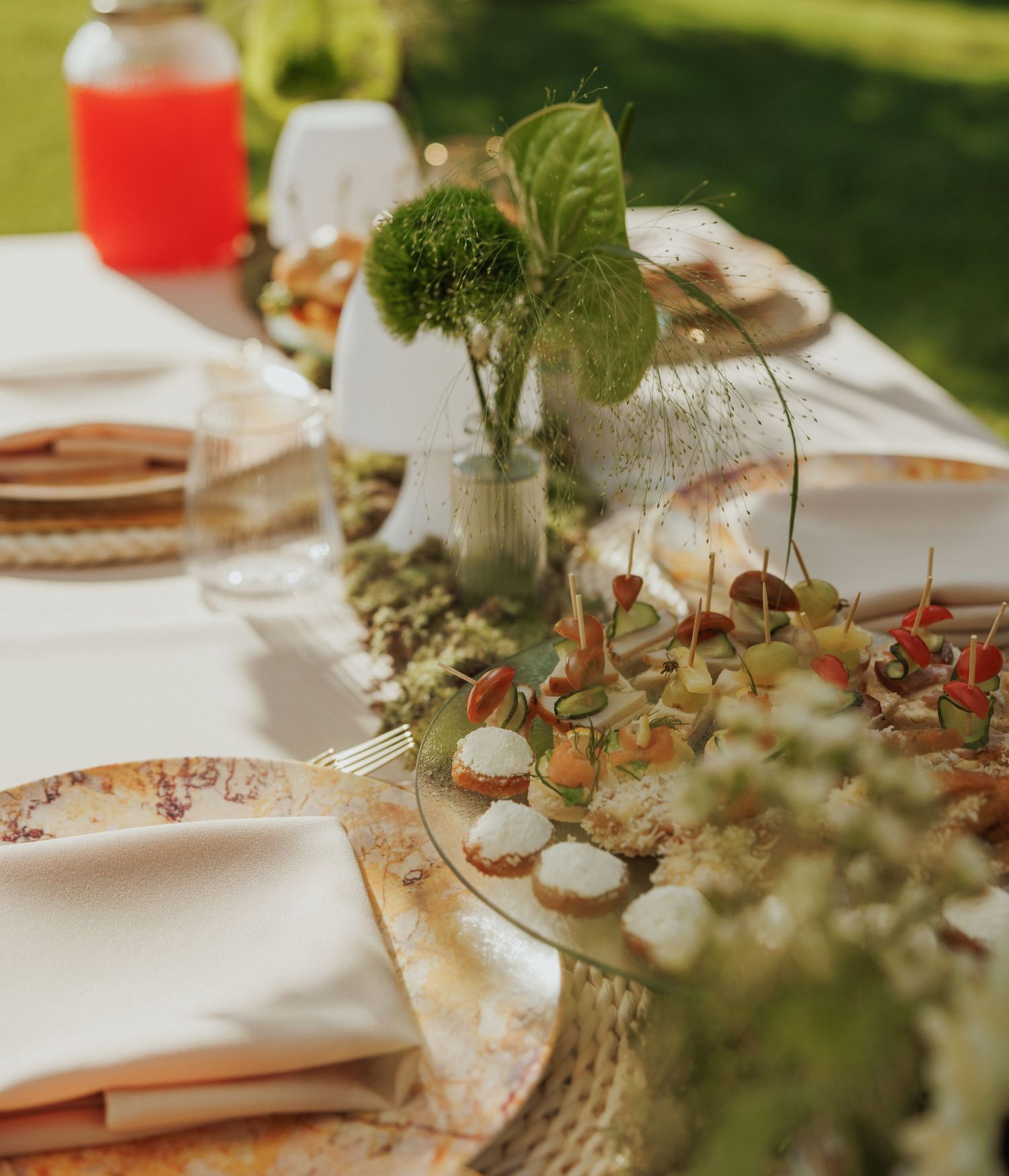 Elegant table setting with natural greenery and rustic decor elements.