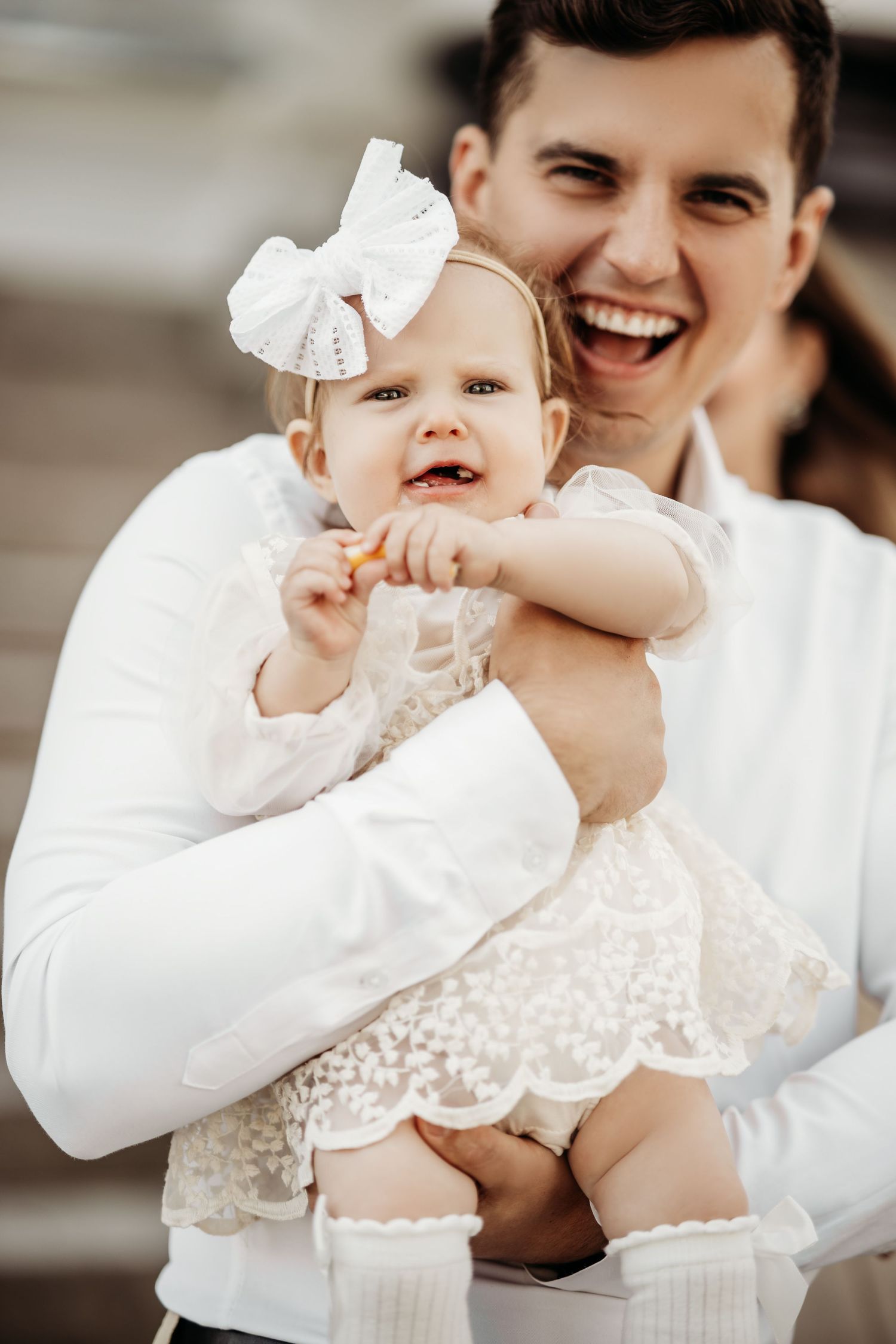 Series of candid photos showing joyful moments with baby in white lace dress.