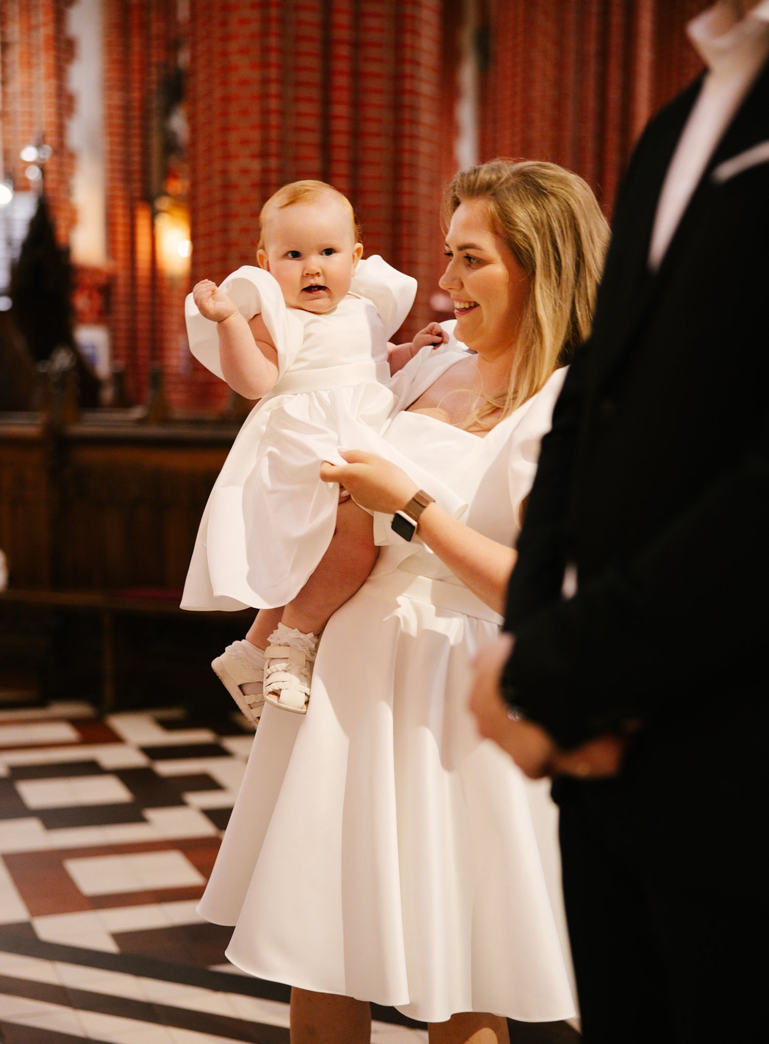 A special celebration moment inside a grand hall with checkered floors and warm lighting.
