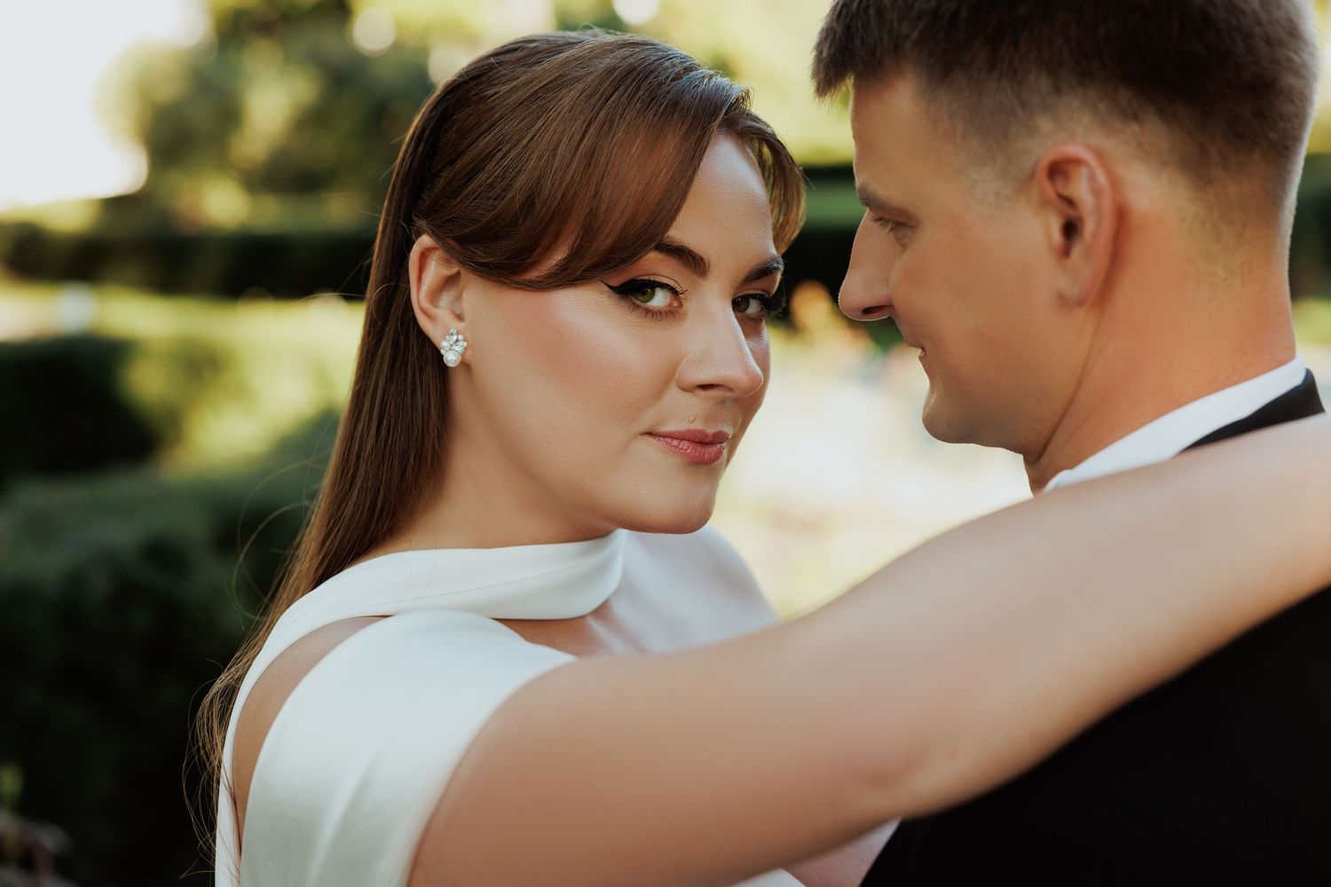 Intimate wedding portrait captured in warm natural lighting.