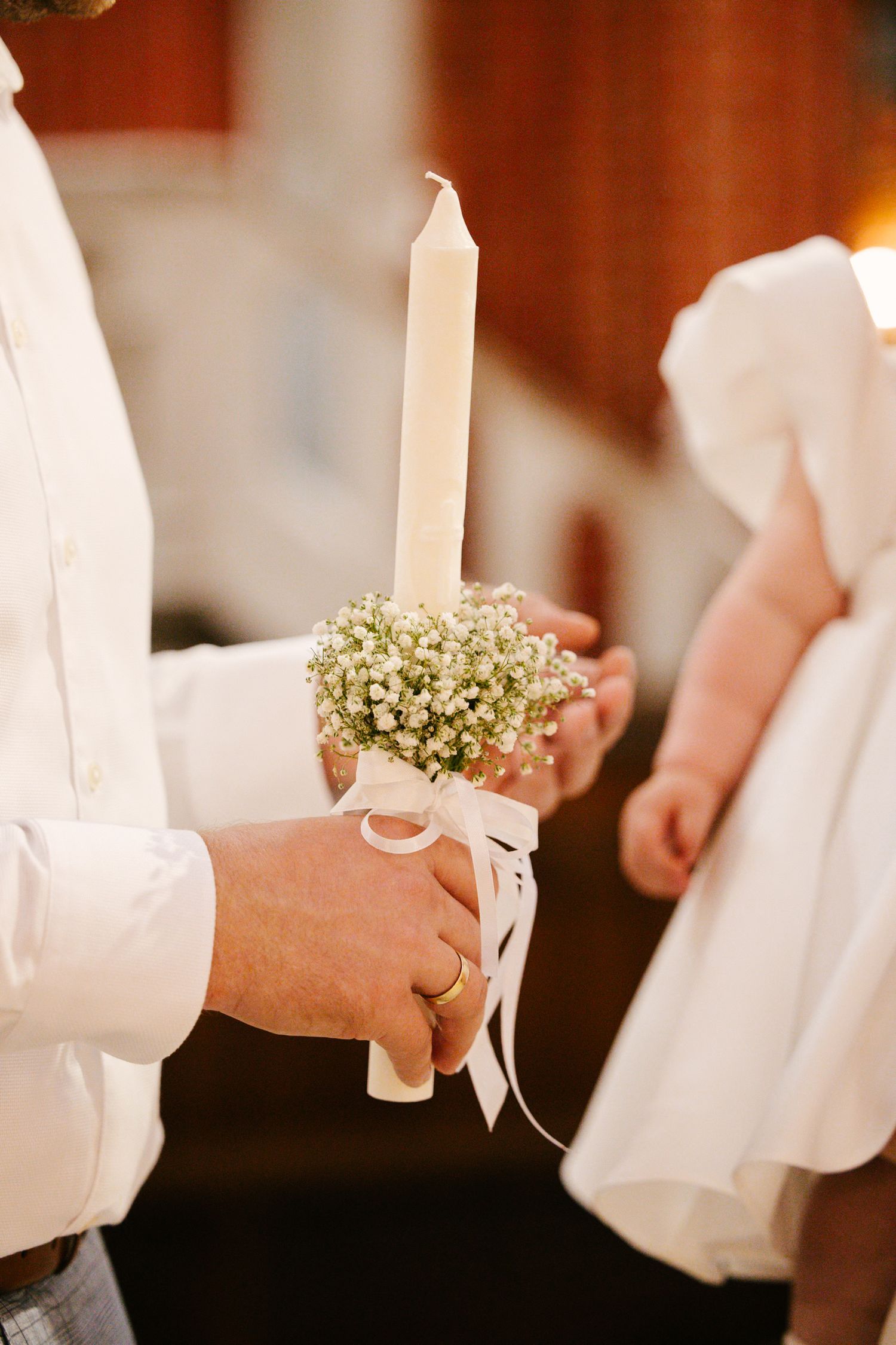 White christening gowns and baby's breath flowers create an elegant baptismal scene.
