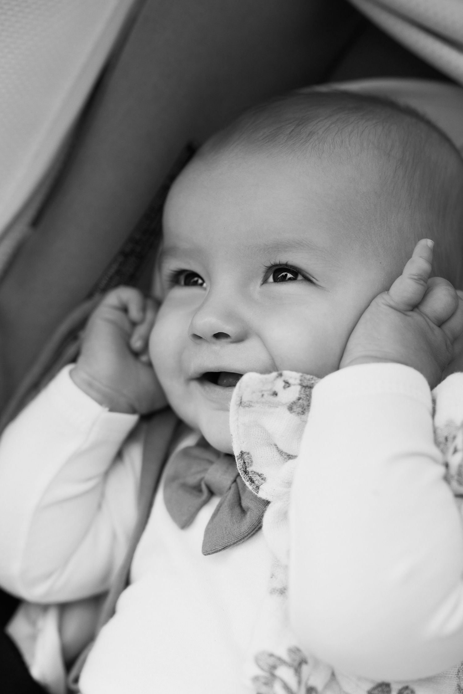 Black and white close-up images of a baby's face showing different expressions and angles.