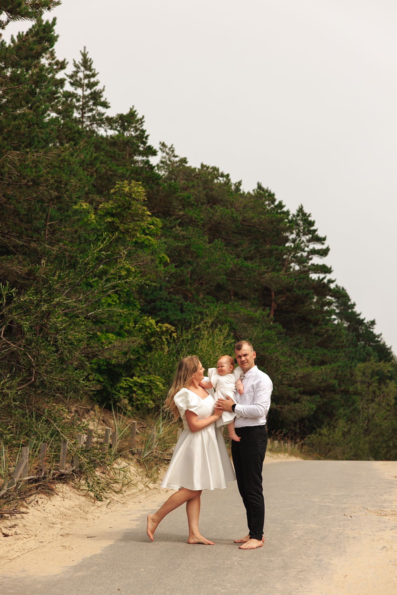 A sequence of candid moments captured on a sandy beach path with pine trees in the background.