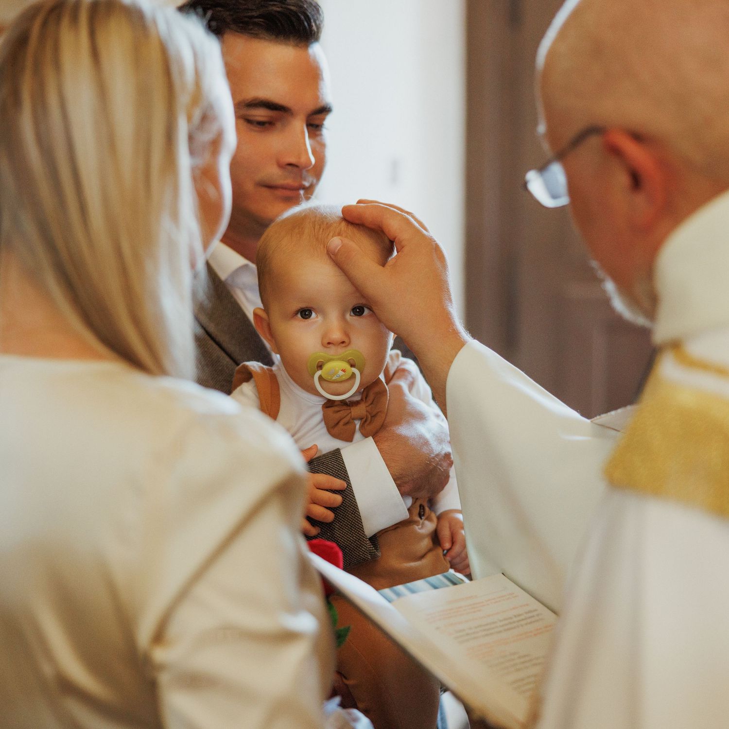 A series of medical examination photos showing a baby being checked by healthcare professionals in white coats.