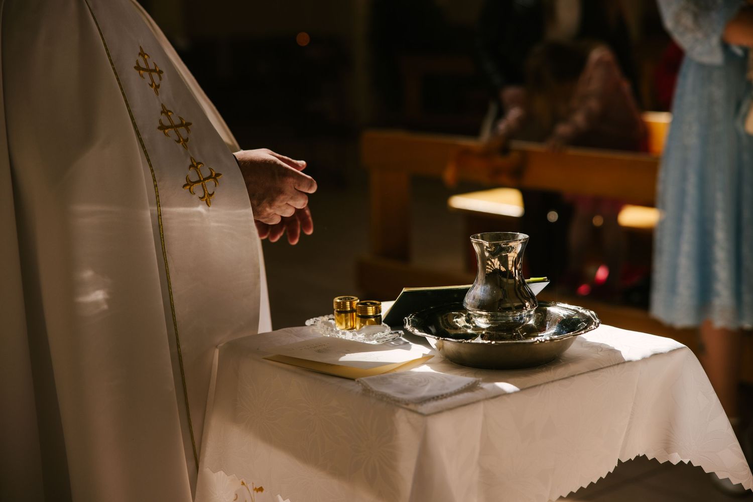 A close-up shot of hands pouring champagne into elegant flutes during a celebratory event.