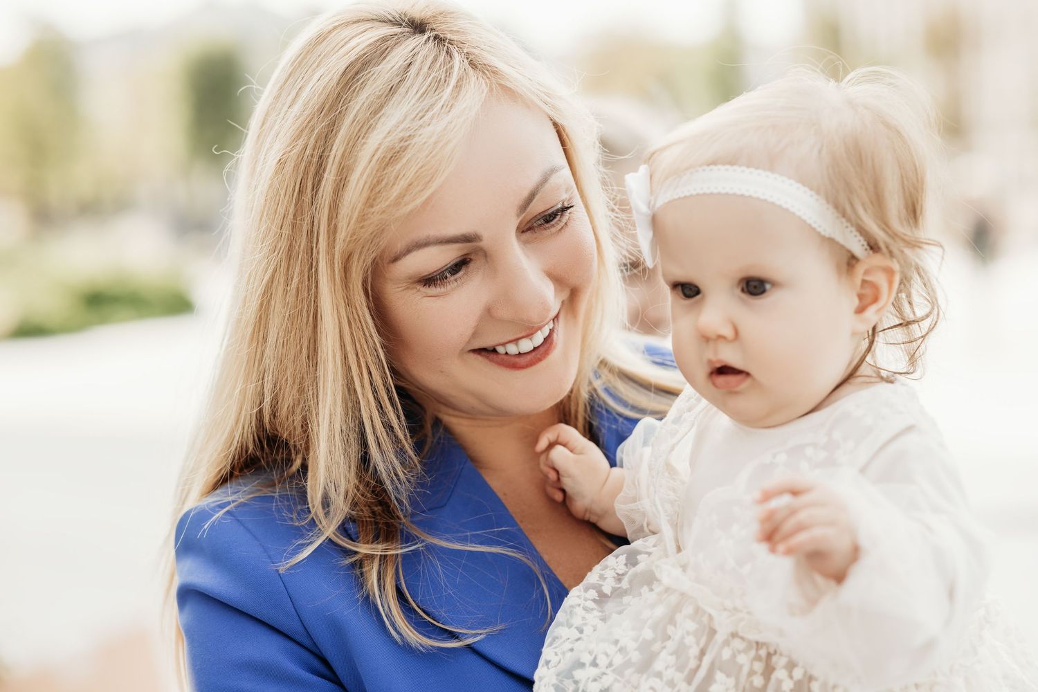 Mother and baby sharing tender moments together in bright natural lighting.