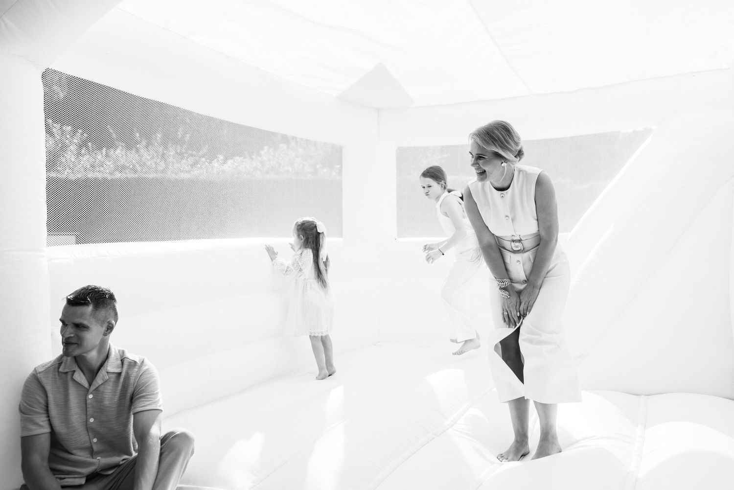 Artistic black and white photography sequence showing movement and interaction in white space.