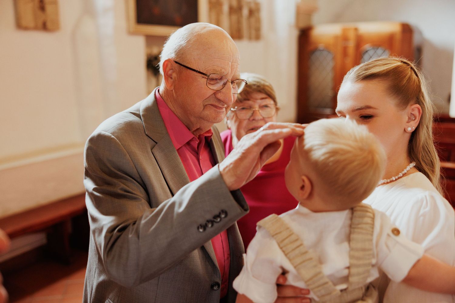 Emotional moments captured during a wedding ceremony showing guests sharing intimate interactions.