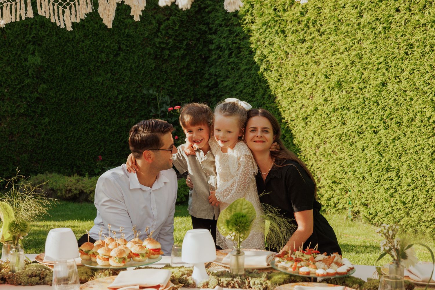 People enjoying food and conversation at an elegant outdoor garden party.