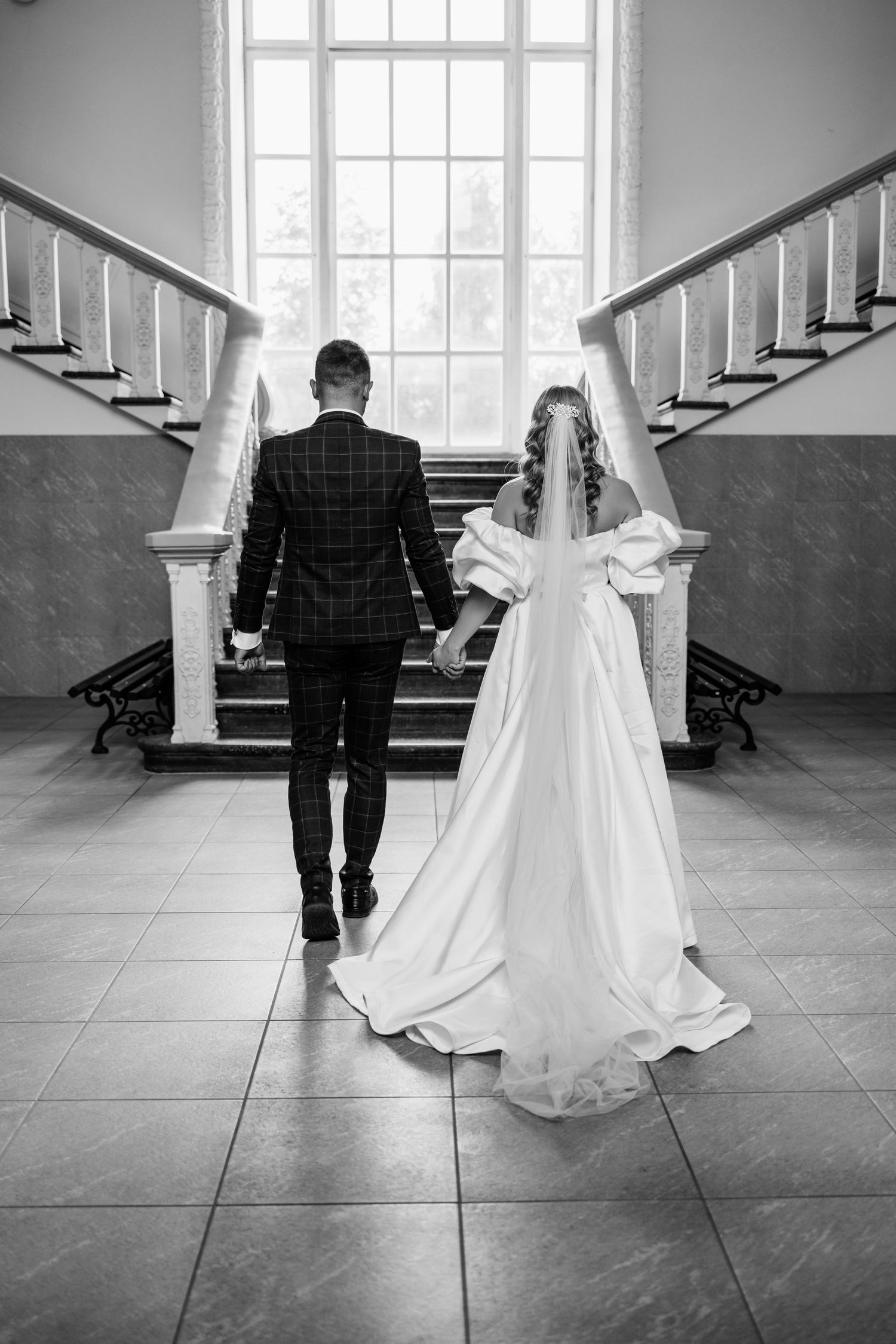 Black and white artistic wedding photo sequence showing couple walking away from camera in elegant church setting.