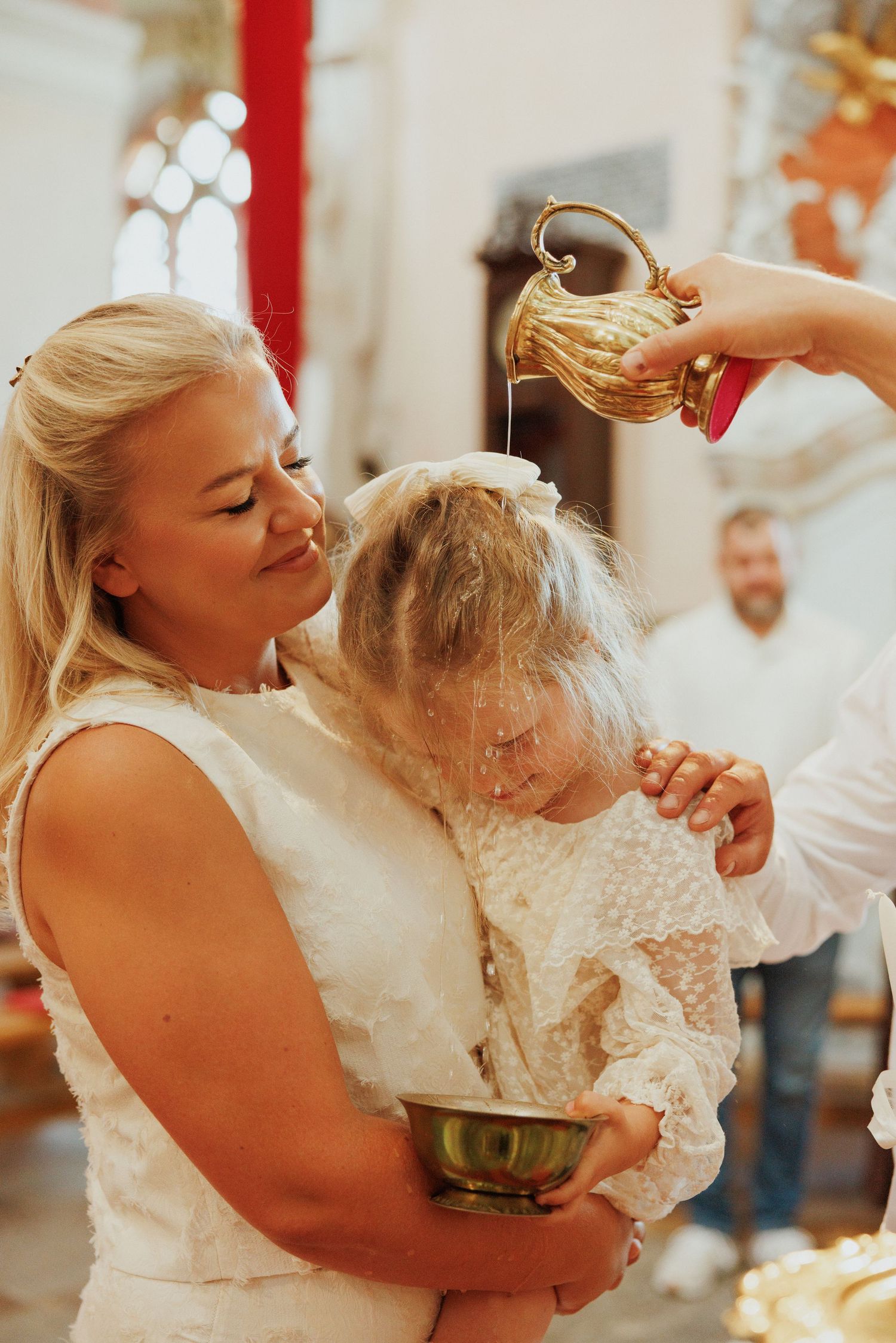 A series of four photos showing a joyful dance between a bride in white and a small child in a lace dress.