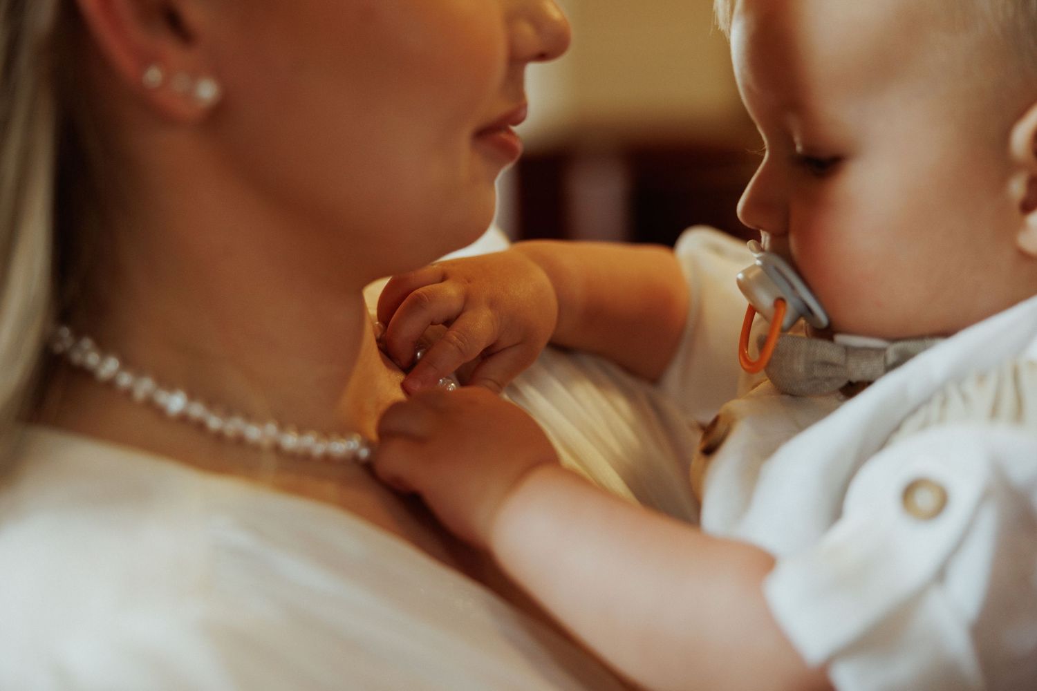 Wedding party members share intimate moments and embraces during a celebration.