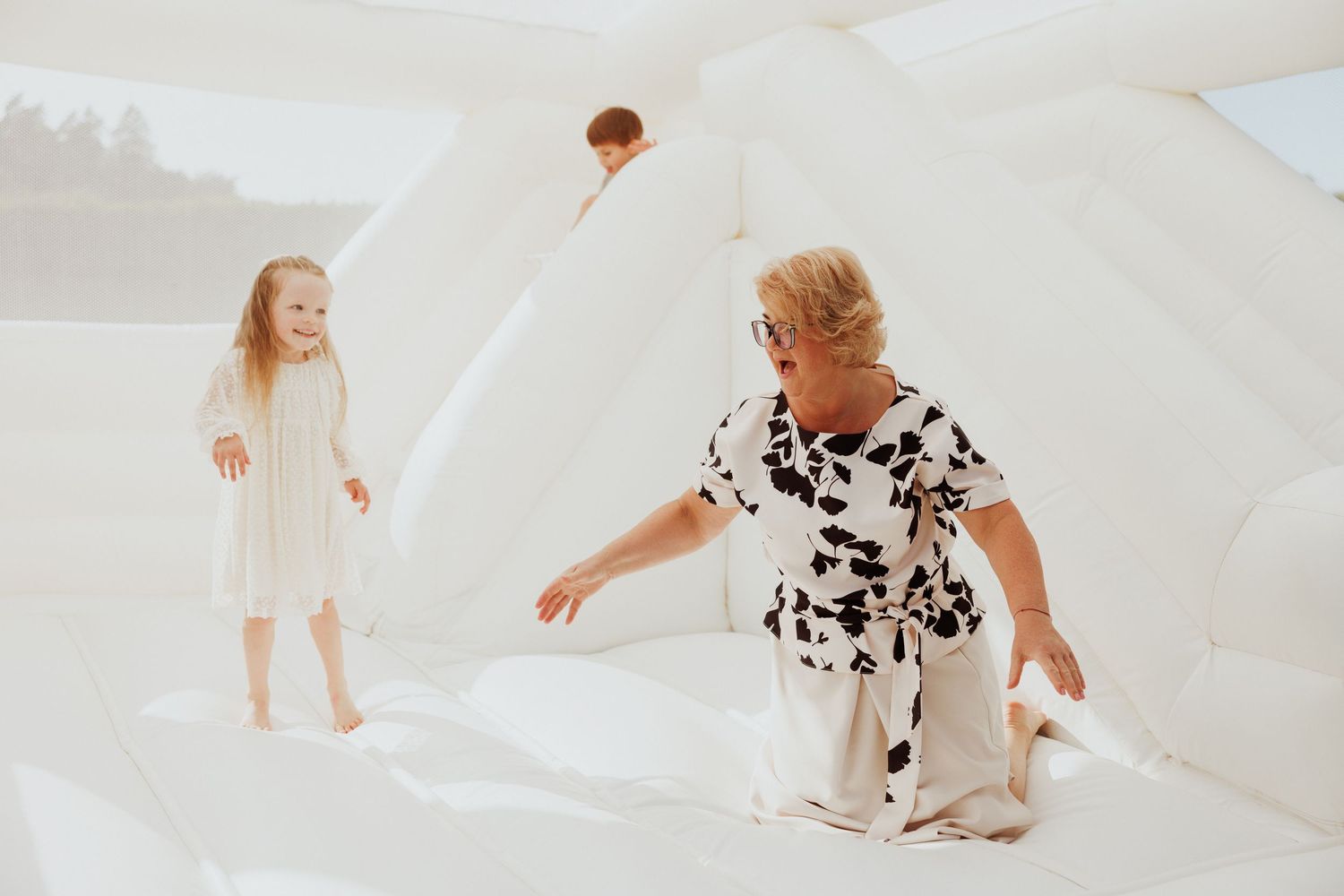 Playful moments captured in bright white studio setting with natural movements.