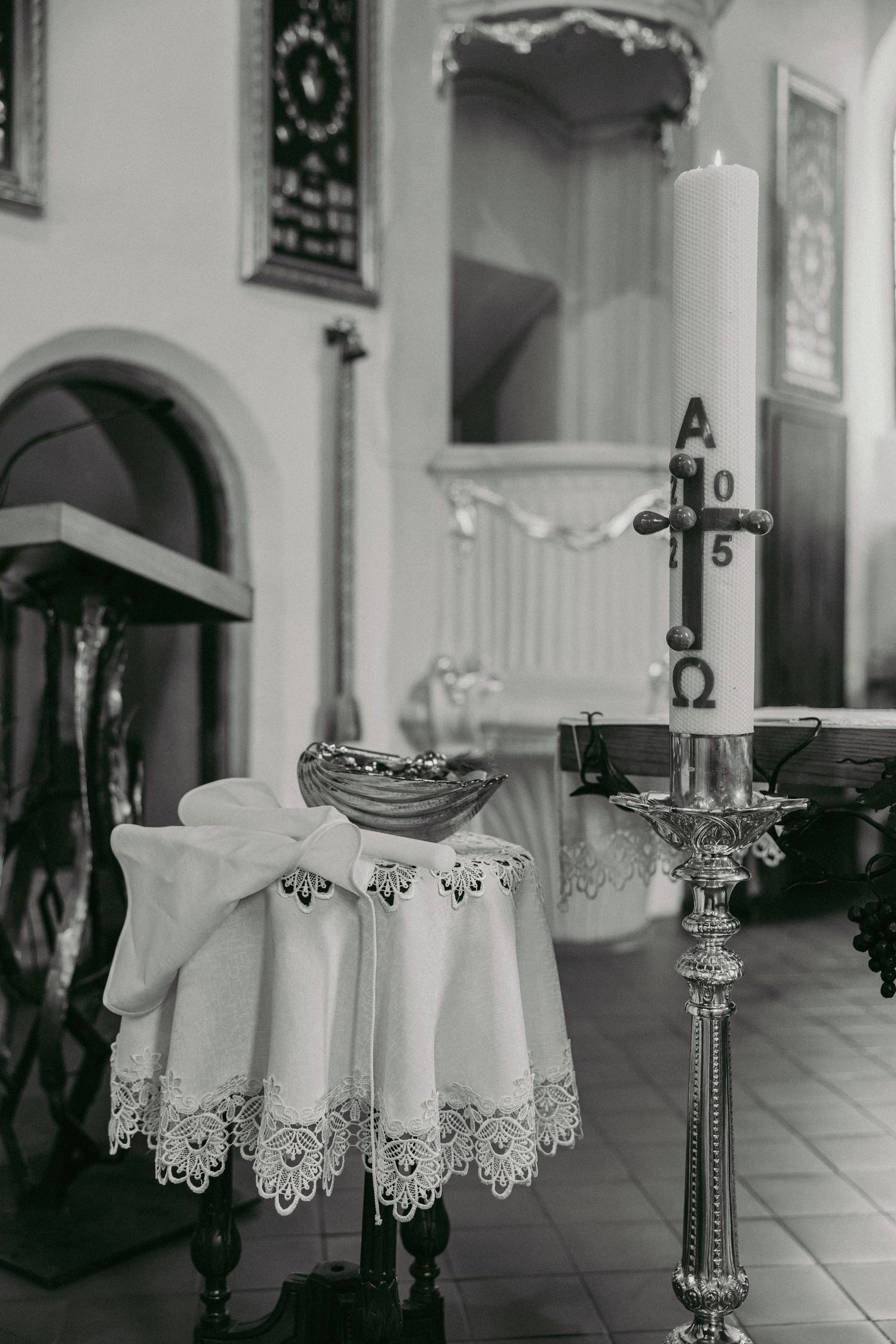 Elegant table settings with lace tablecloths and ornate candelabras in a formal dining space.