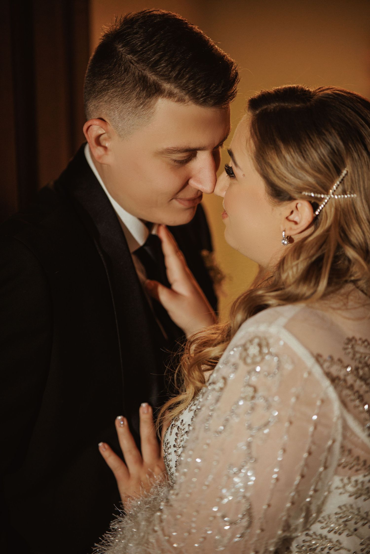 Romantic couple portraits in sparkly dress and dark suit.
