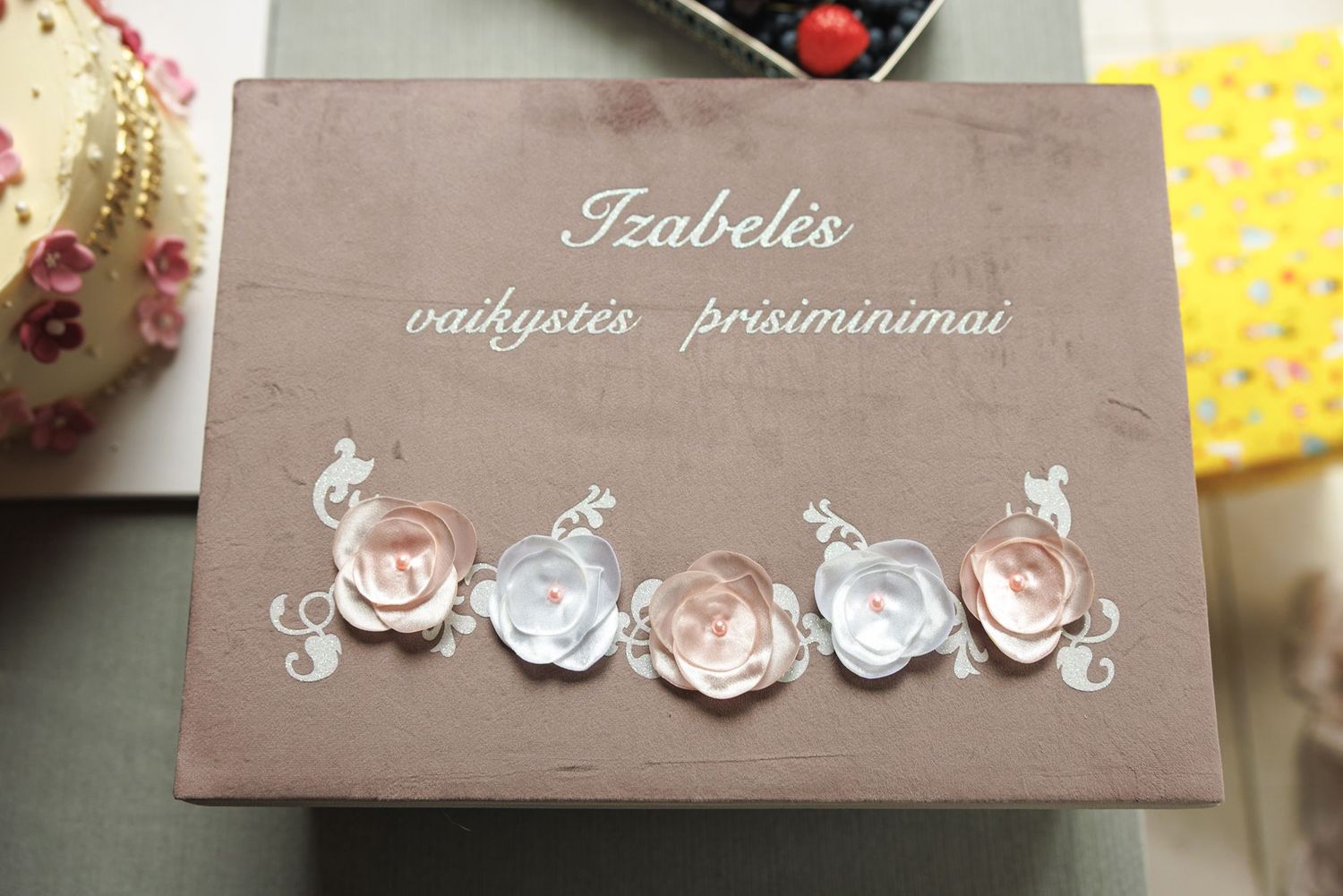 Brown decorative name card with delicate white ornamental designs for table settings.