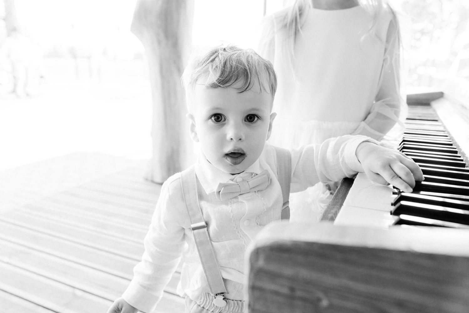 A collage of black and white photos showing a baby playing and exploring at different moments during the day.