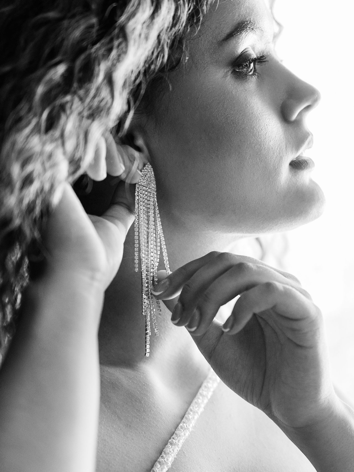 Artistic black and white series featuring dangling crystal earrings and elegant profile poses.
