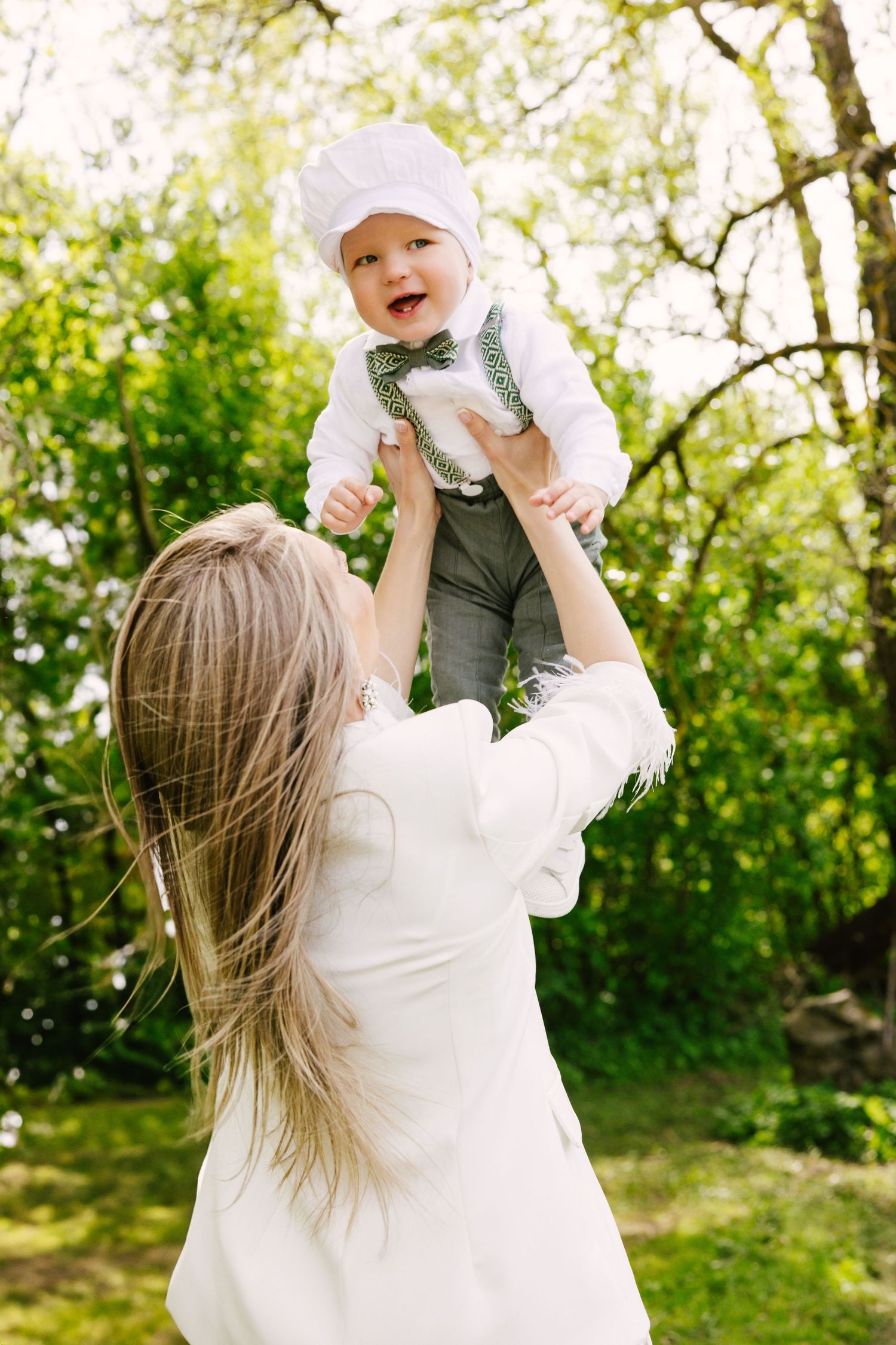 A joyful family plays together outdoors in a series of candid shots against a lush green background.