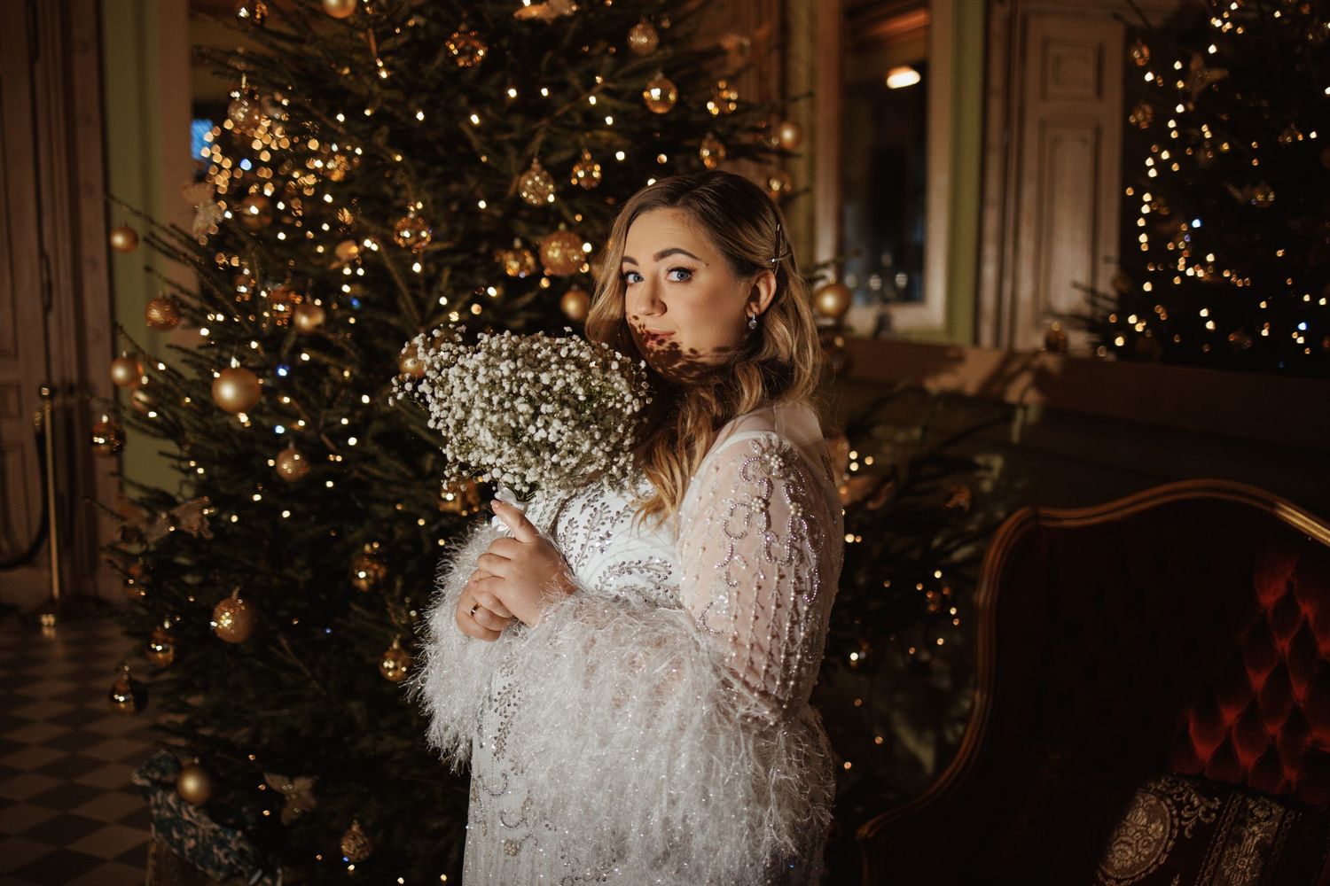 Wedding photos with sparkly dress against Christmas lights.