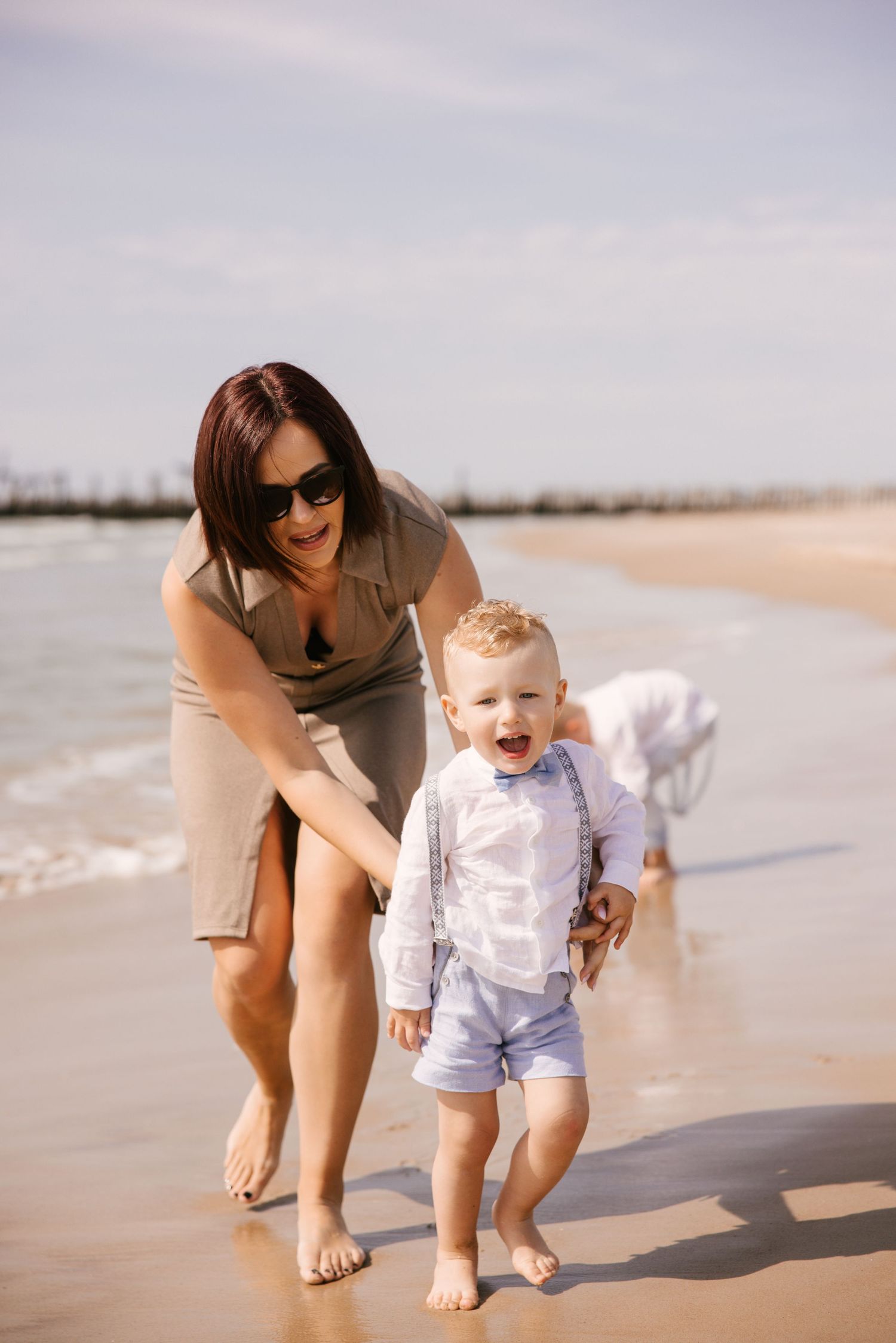 Sweet moments captured during a beachside photo session at sunset.