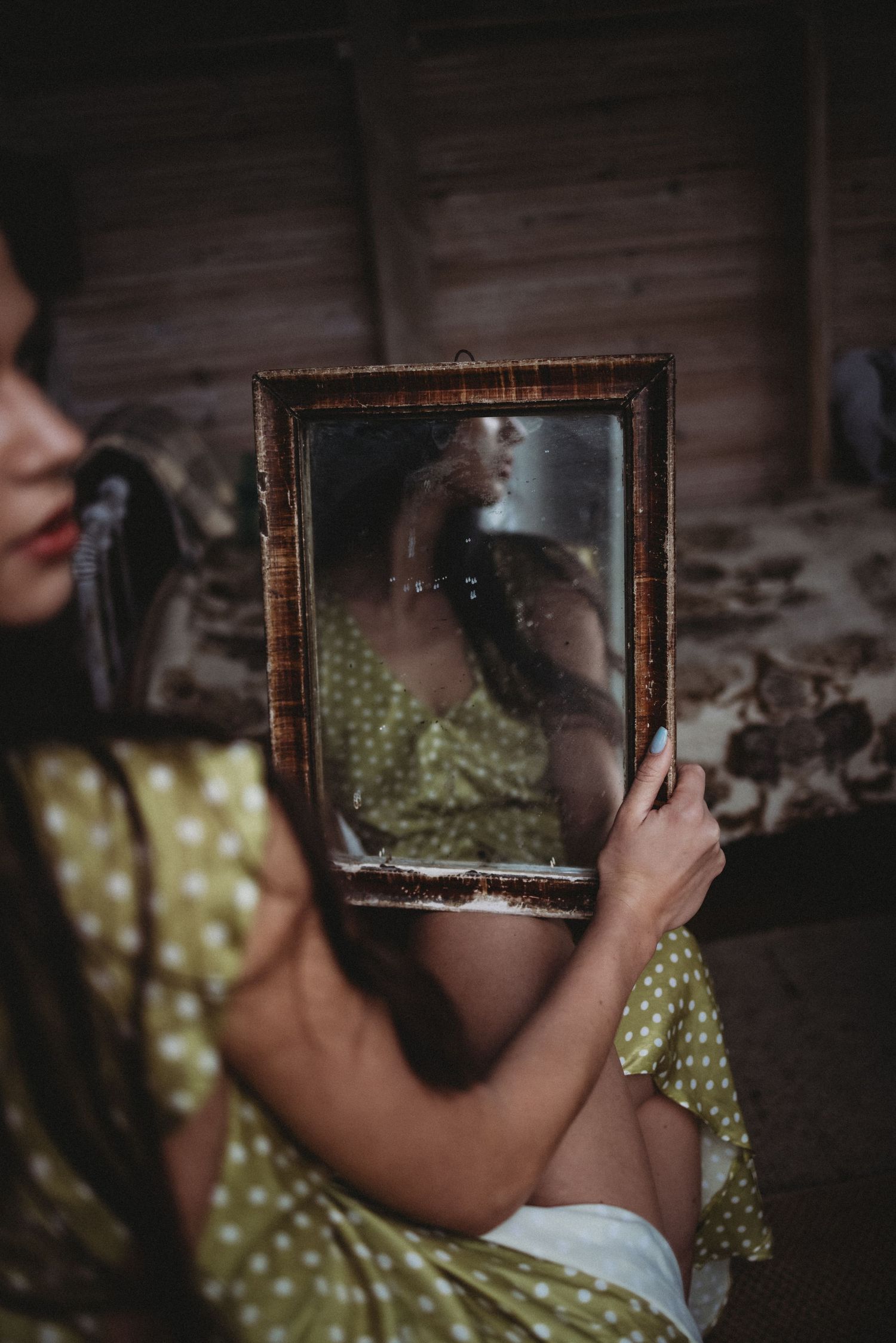 Artistic composition with antique mirror frame creating layered reflections.