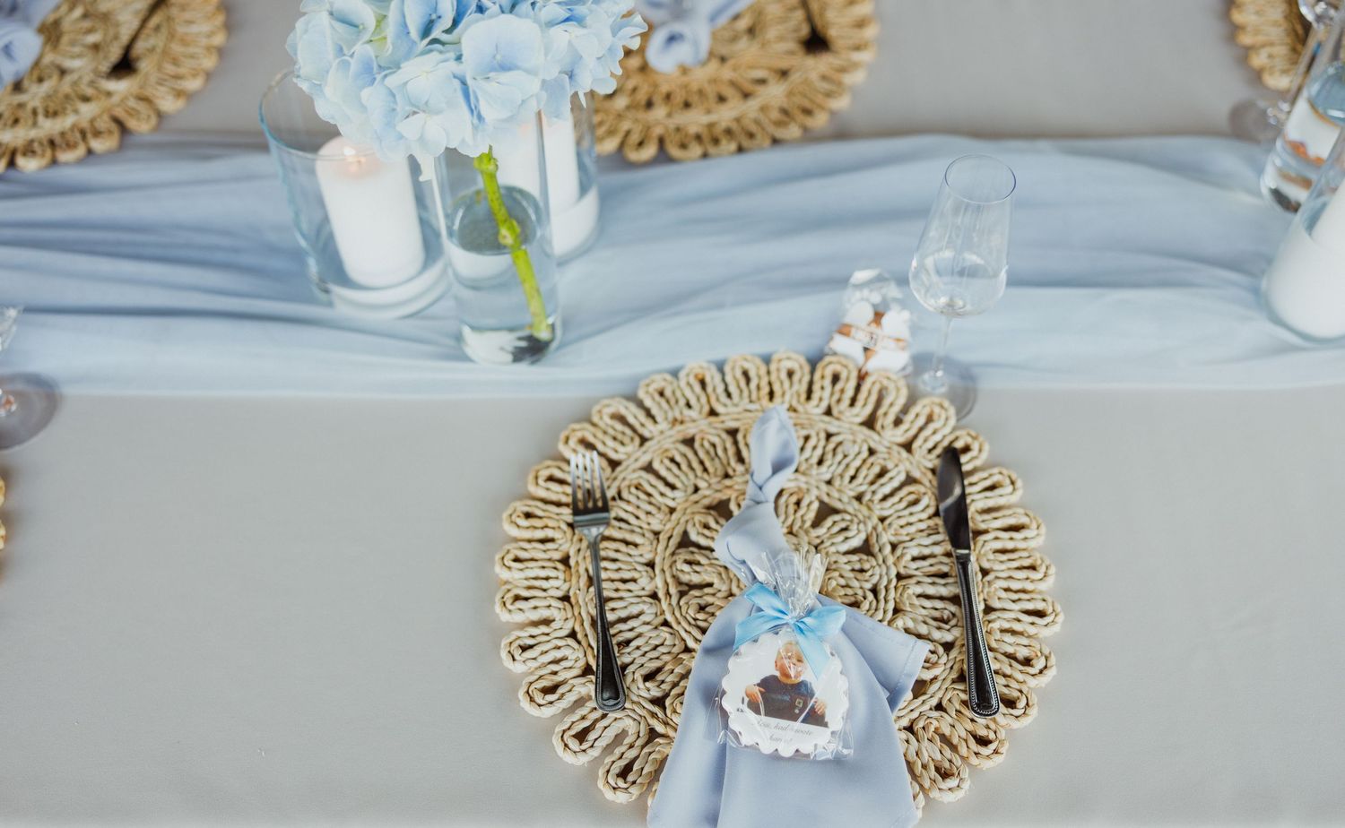 Decorative gold placemats and light blue table settings create an elegant dining arrangement.