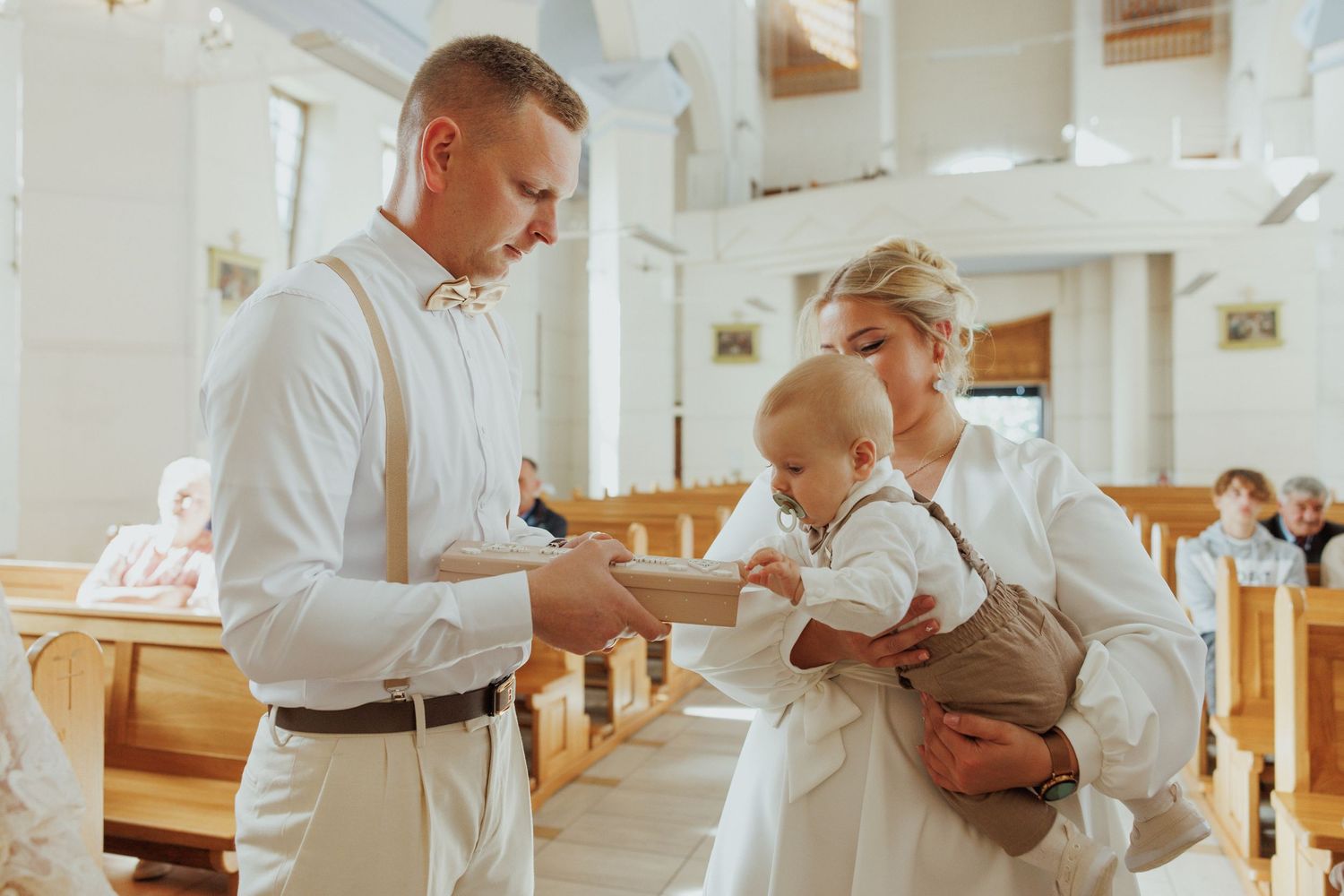 Restaurant patrons in white shirts sit at a wooden table in a bright, modern dining space.