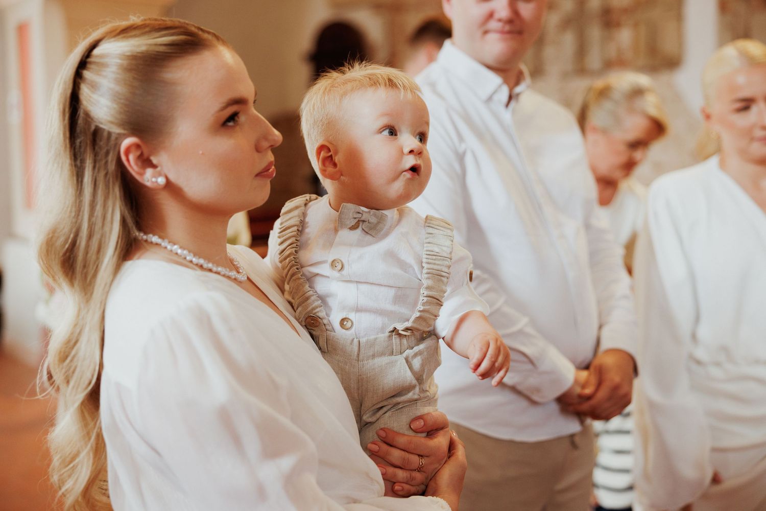 A group of people dressed in white gather together for a formal occasion or celebration.