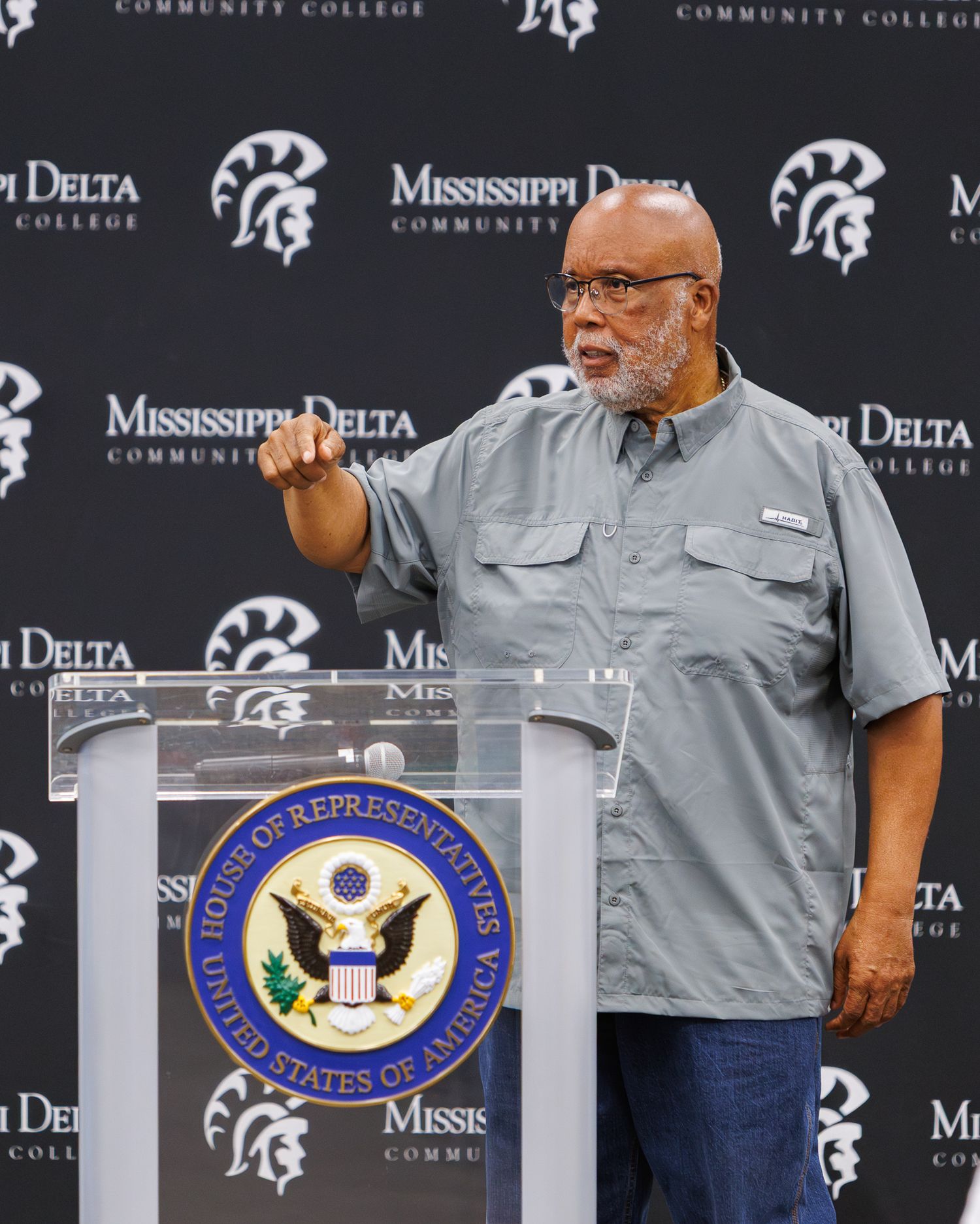 Mississippi Delta Community College logo display with officials at podium. Congressman Bennie Thompson speaking.