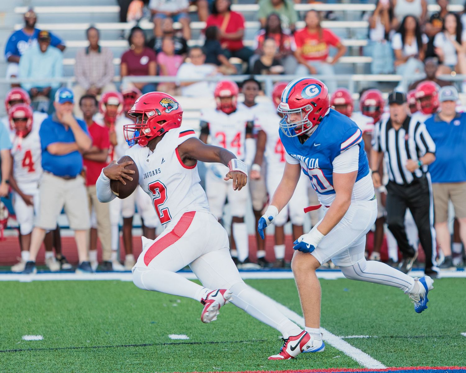 Football players execute diving plays during a competitive game on the field.