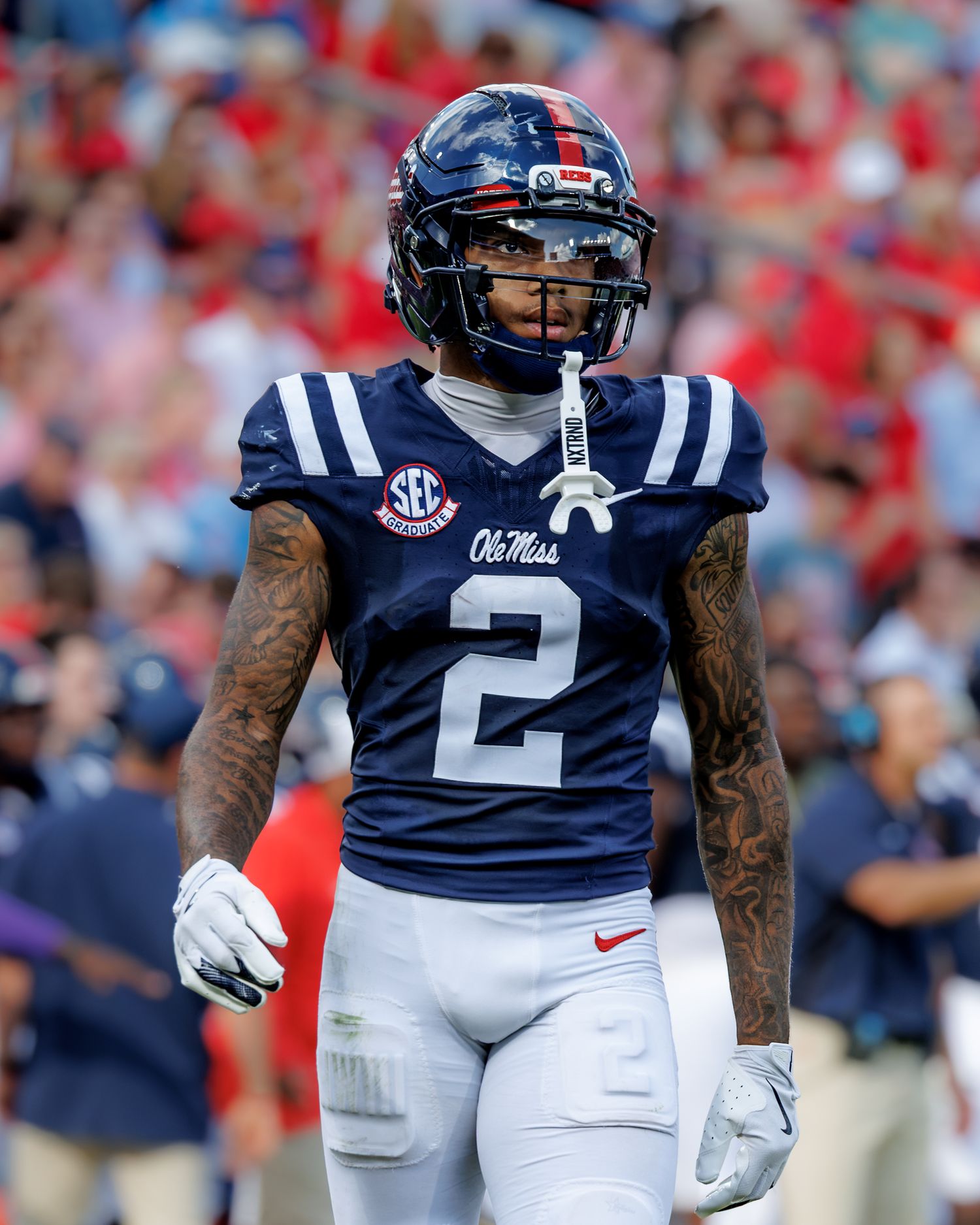 Ole Miss Rebels football player wearing navy blue #2 jersey and white pants on the field during a game.