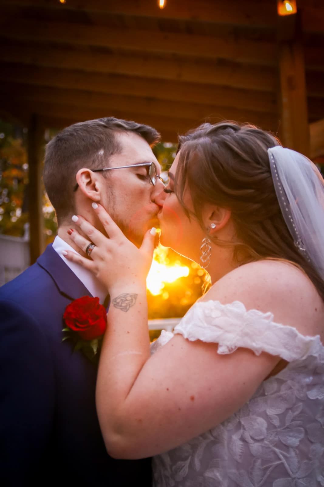 A sunset wedding kiss captured with warm golden lighting and romantic ambiance.