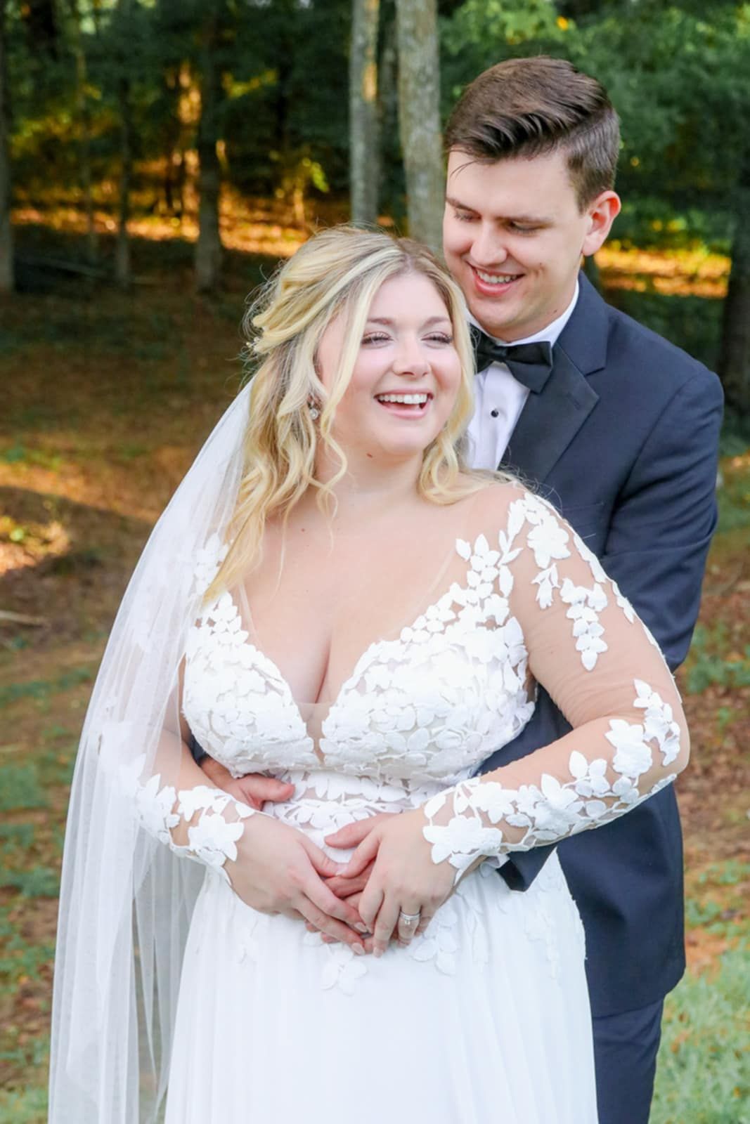 A joyful wedding moment captured with delicate lace details and a flowing veil.