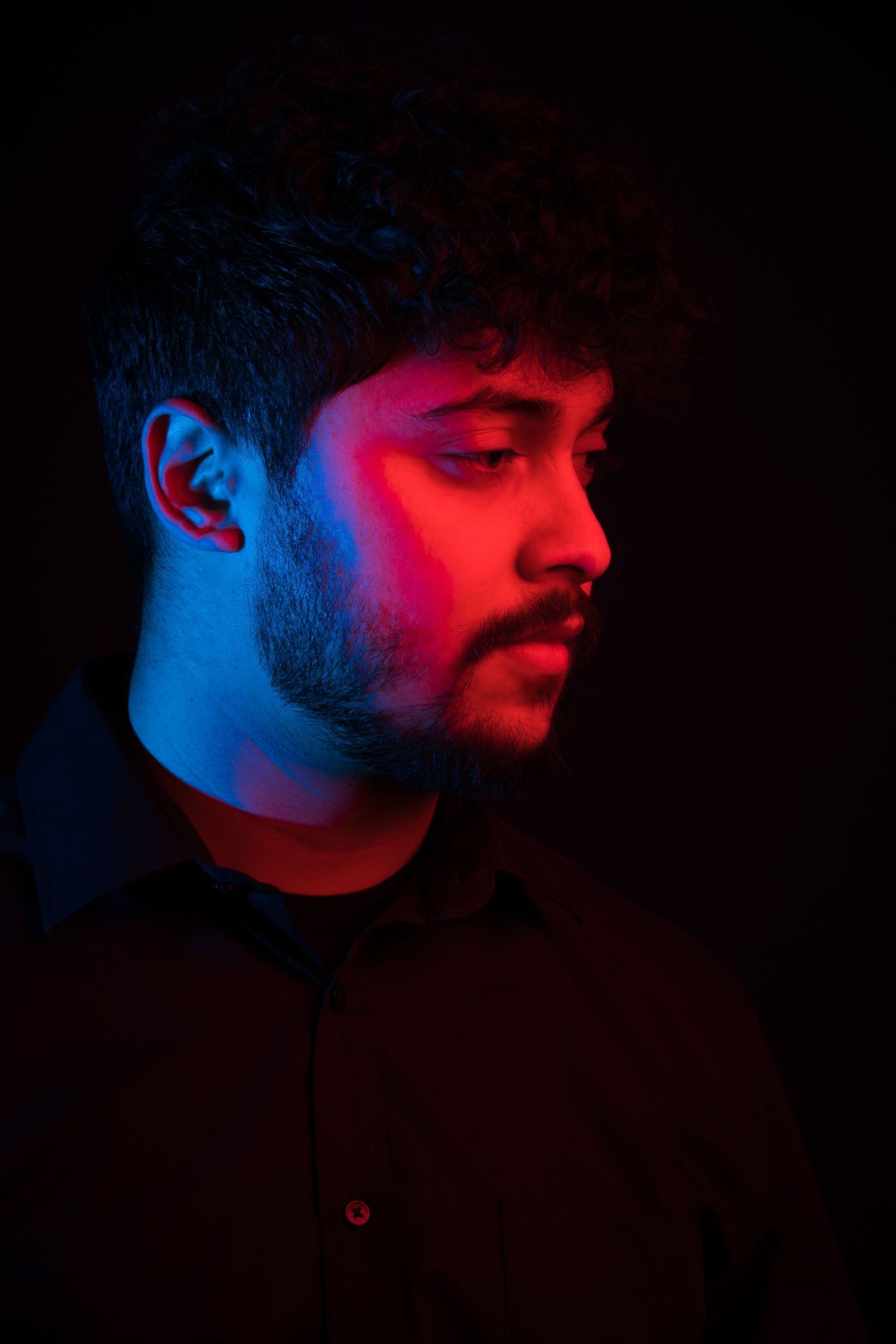 Artistic profile shots with dramatic red and blue lighting creating a moody atmosphere.