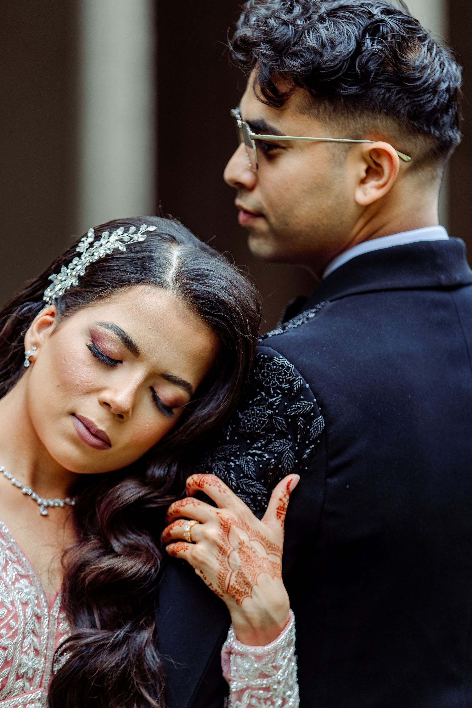Intimate close-up of couple in formal South Asian wedding attire.