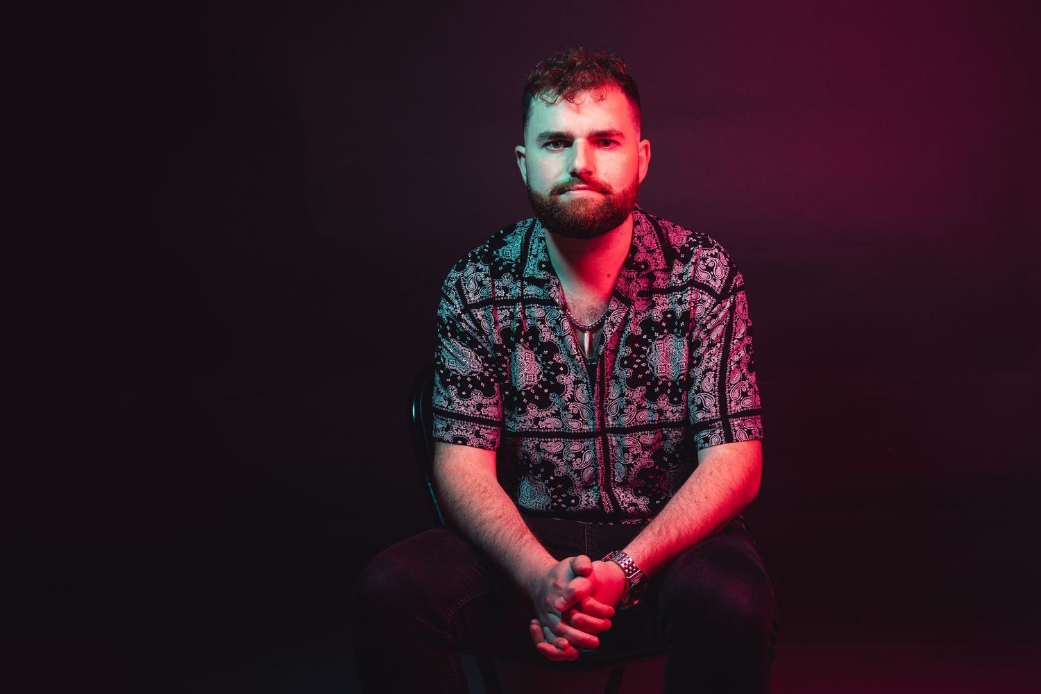 Professional portrait series with dramatic red and blue lighting effects against a dark background.