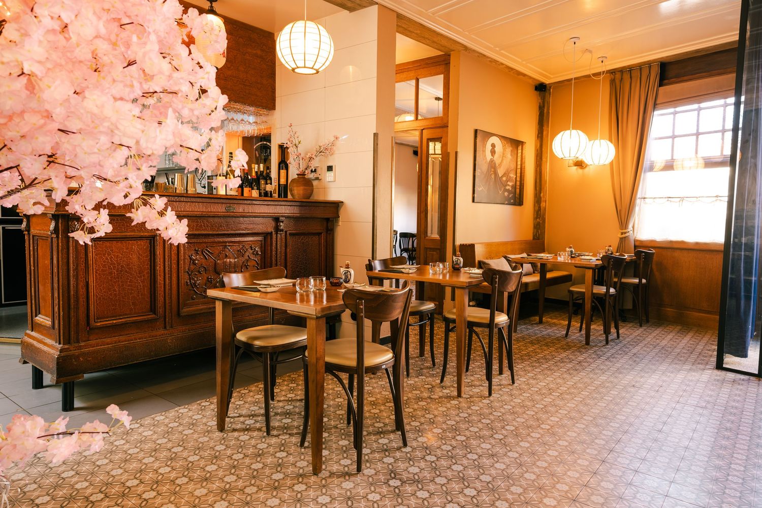 Elegant restaurant dining room with cherry blossom decor and wooden furniture.