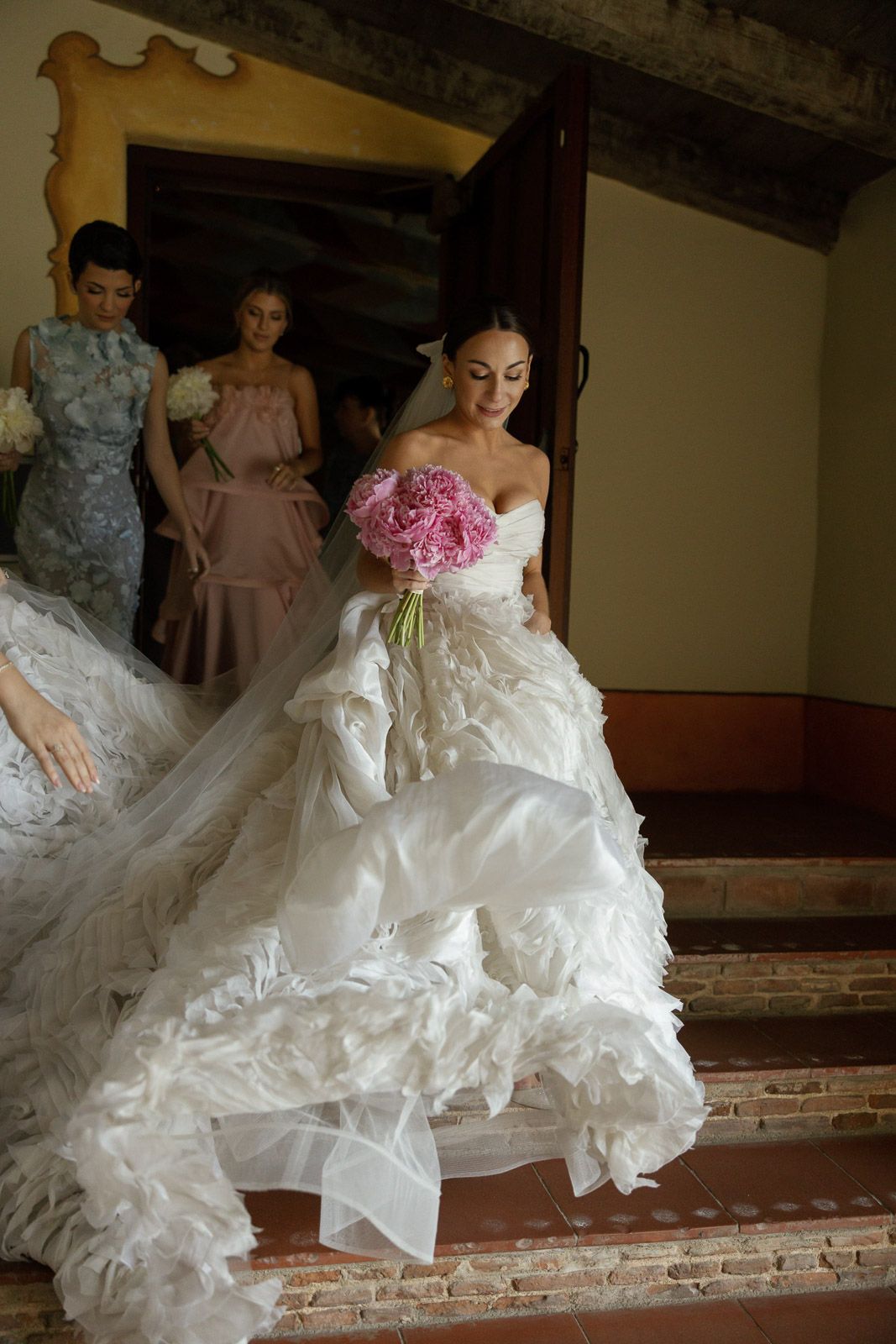 Wedding portrait photography of a bride walking toward her ceremony at Carmel Mission Basilica.