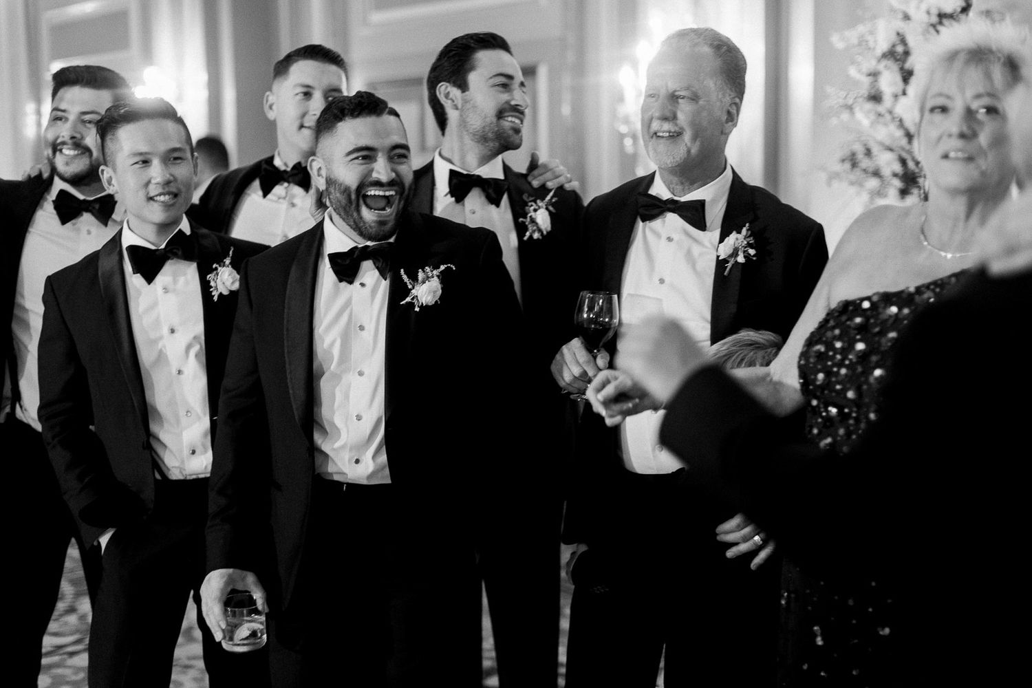 Wedding celebration with guests in formal attire enjoying festivities.