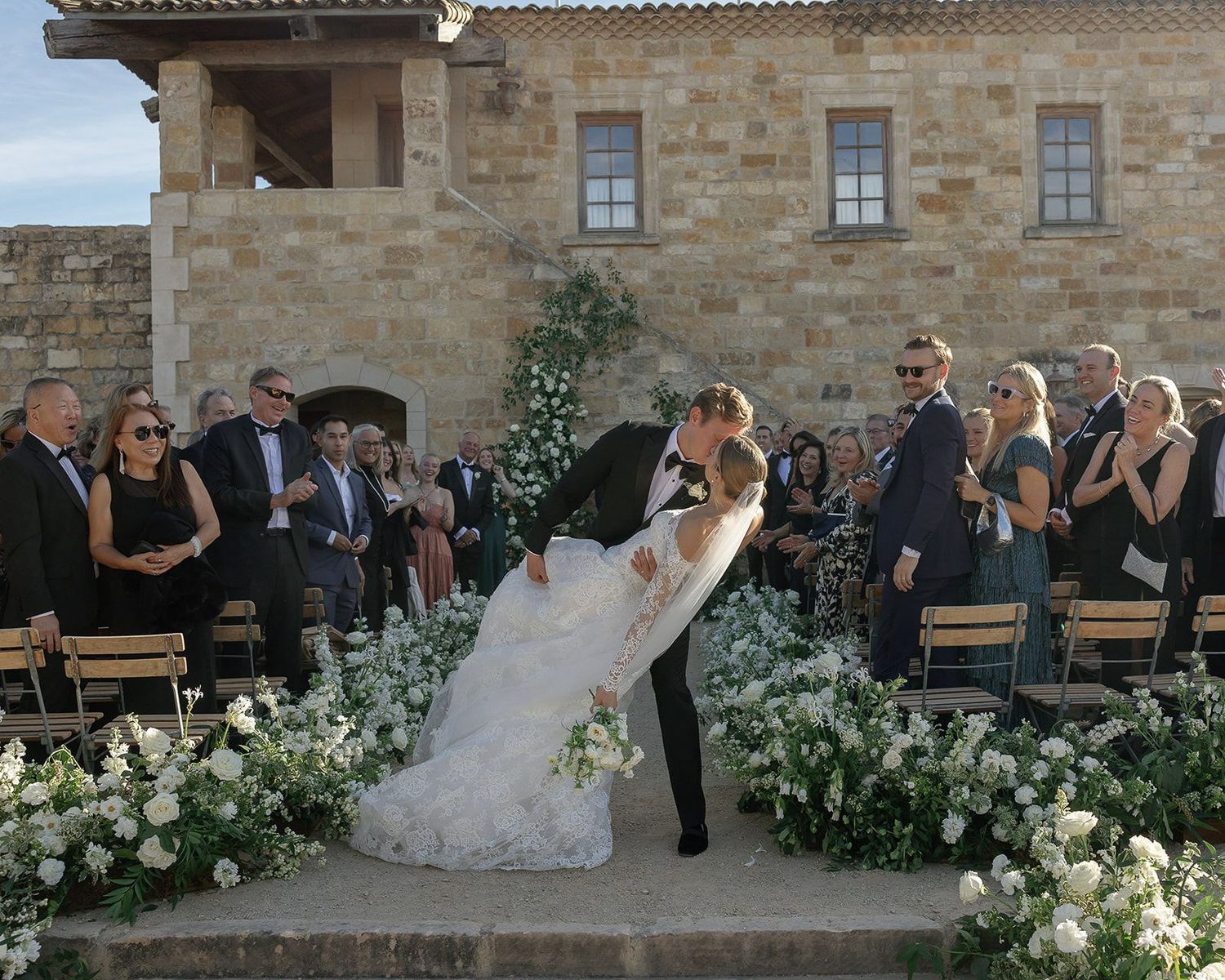 W edding ceremony photography of a couple kissing down the aisle at Sunstone Winery in Santa Ynez, California.