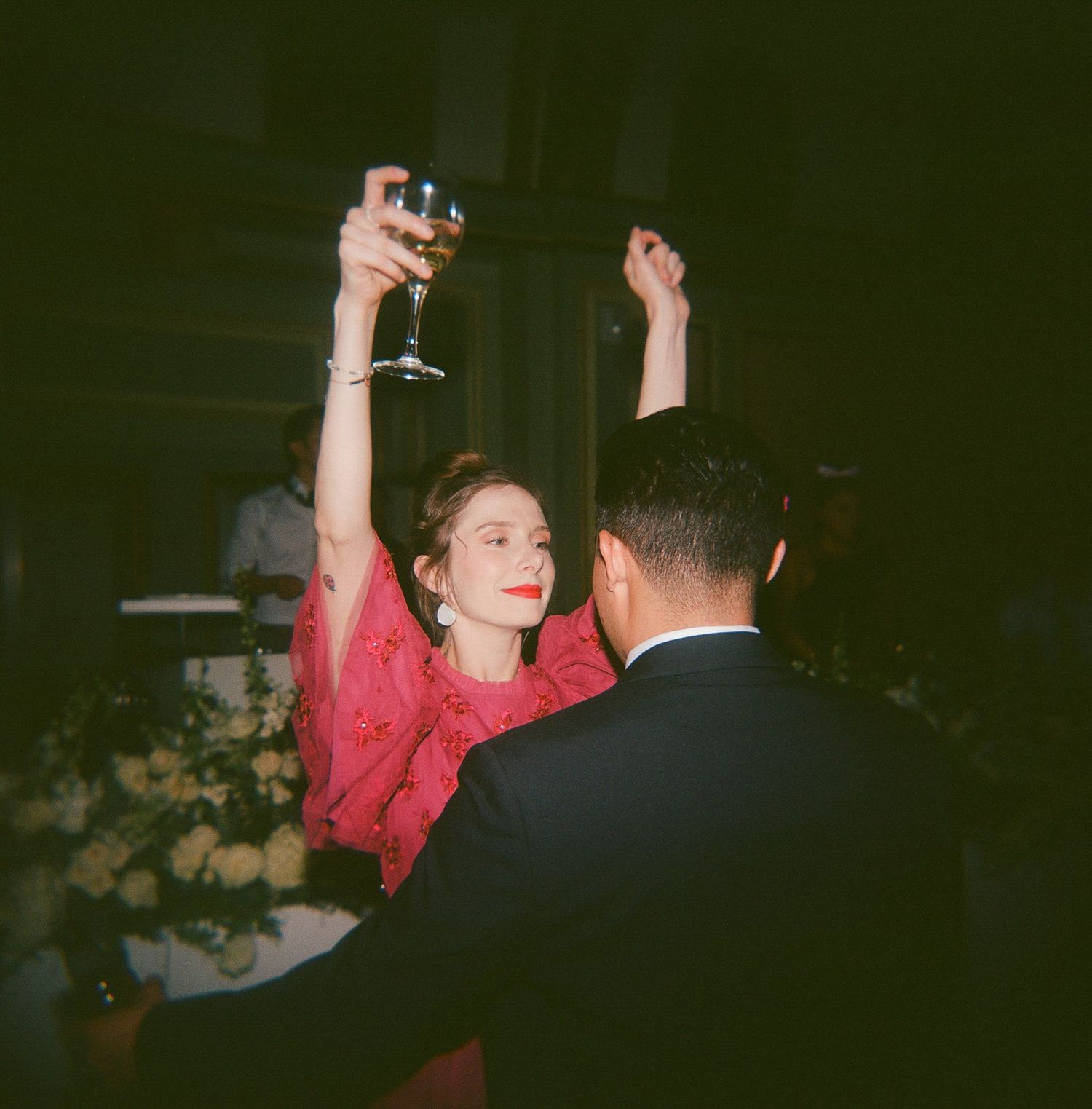 Wedding reception dance floor with celebratory atmosphere in dark lighting.