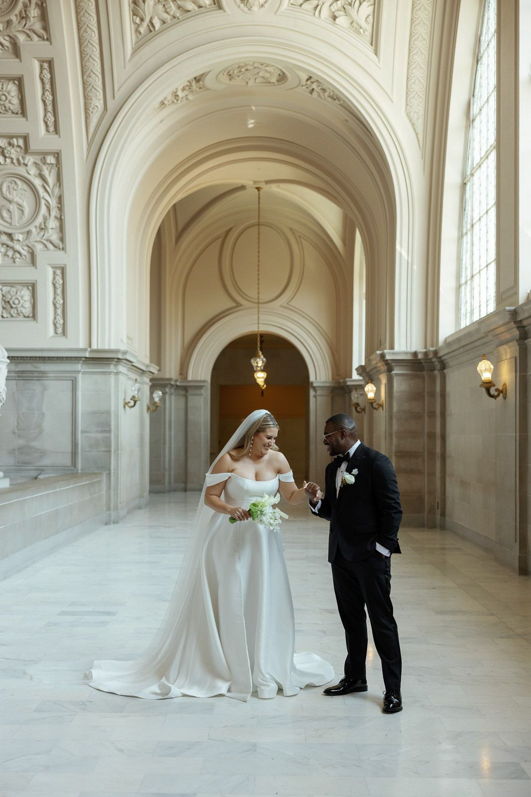 Wedding portrait photography of a bride and groom at San Francisco City Hall in San Francisco, California.