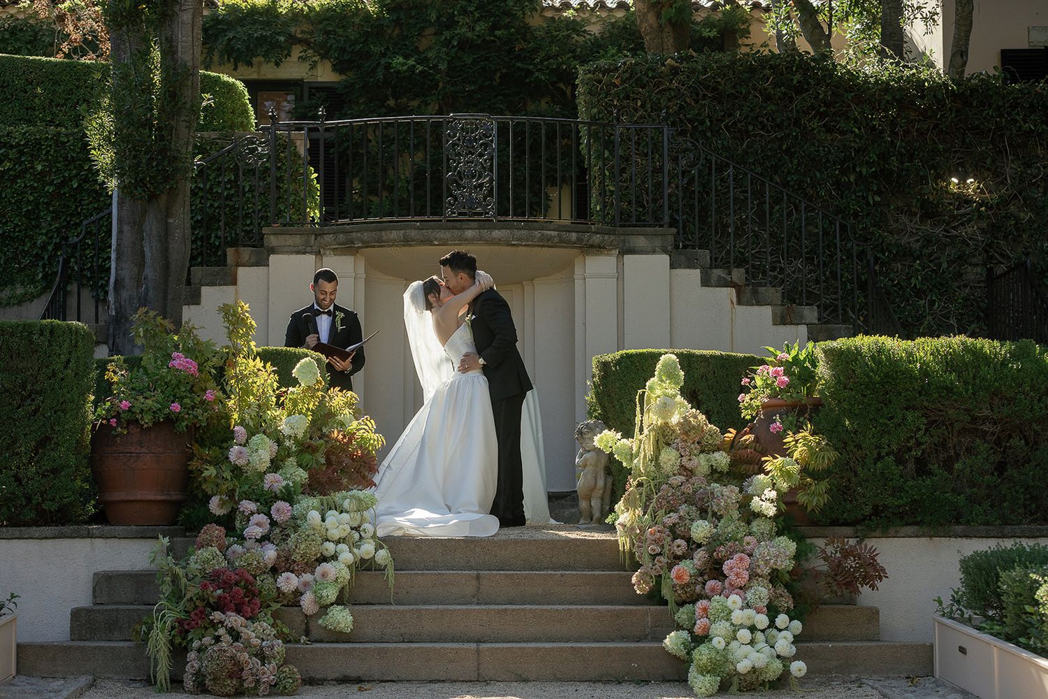 Bride and groom kissing during ceremony at Stonepine Estate in Carmel Valley