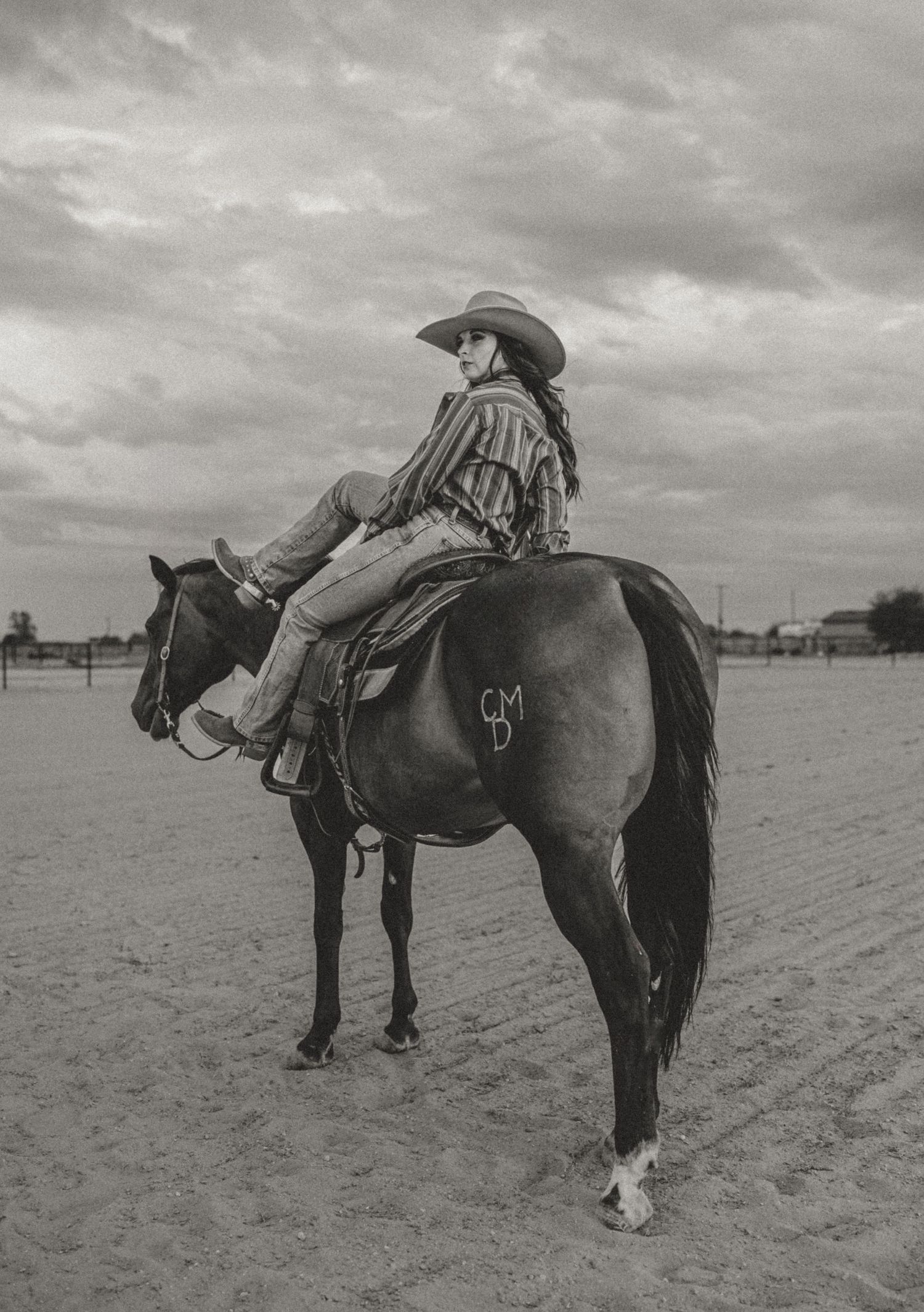 A sequence of black and white photos showing a rider mounting a horse in a dusty field under cloudy skies.