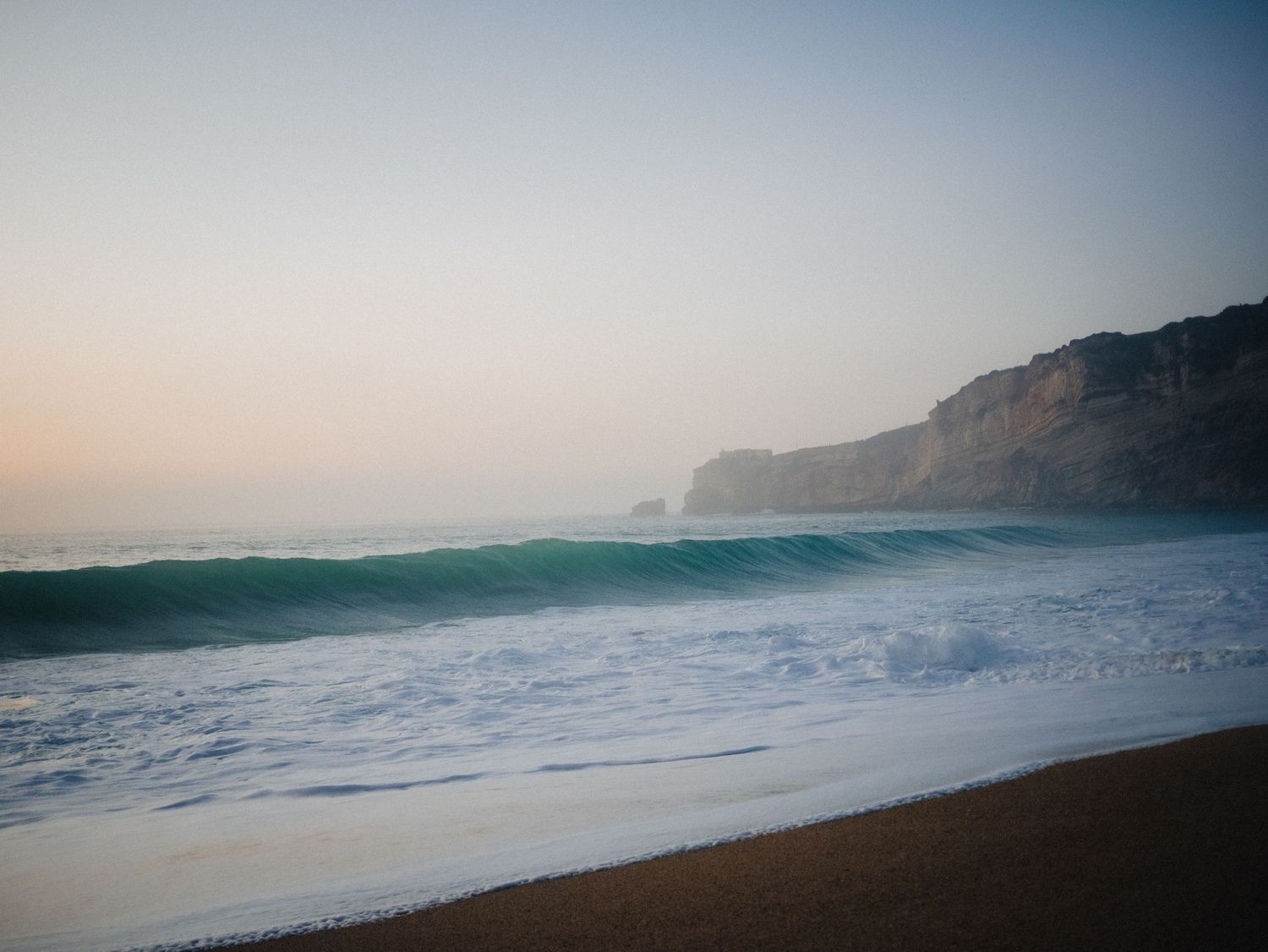 Clean line that I remember. A single wave at Dusk at Nazare, Portugal during Autumn 2023. © Jack Curtis Photography.